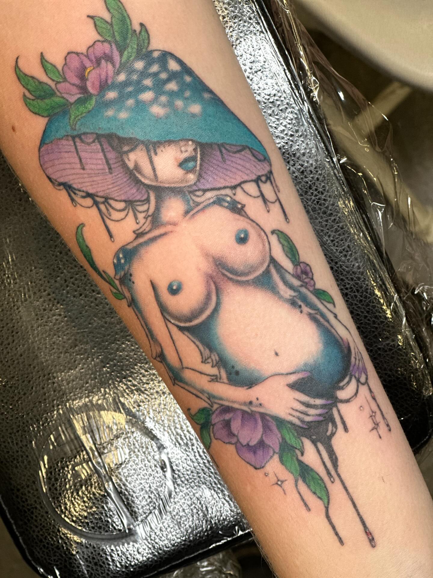 Pregnant woman with mushroom new school tattoo on the forearm by Michele Estes