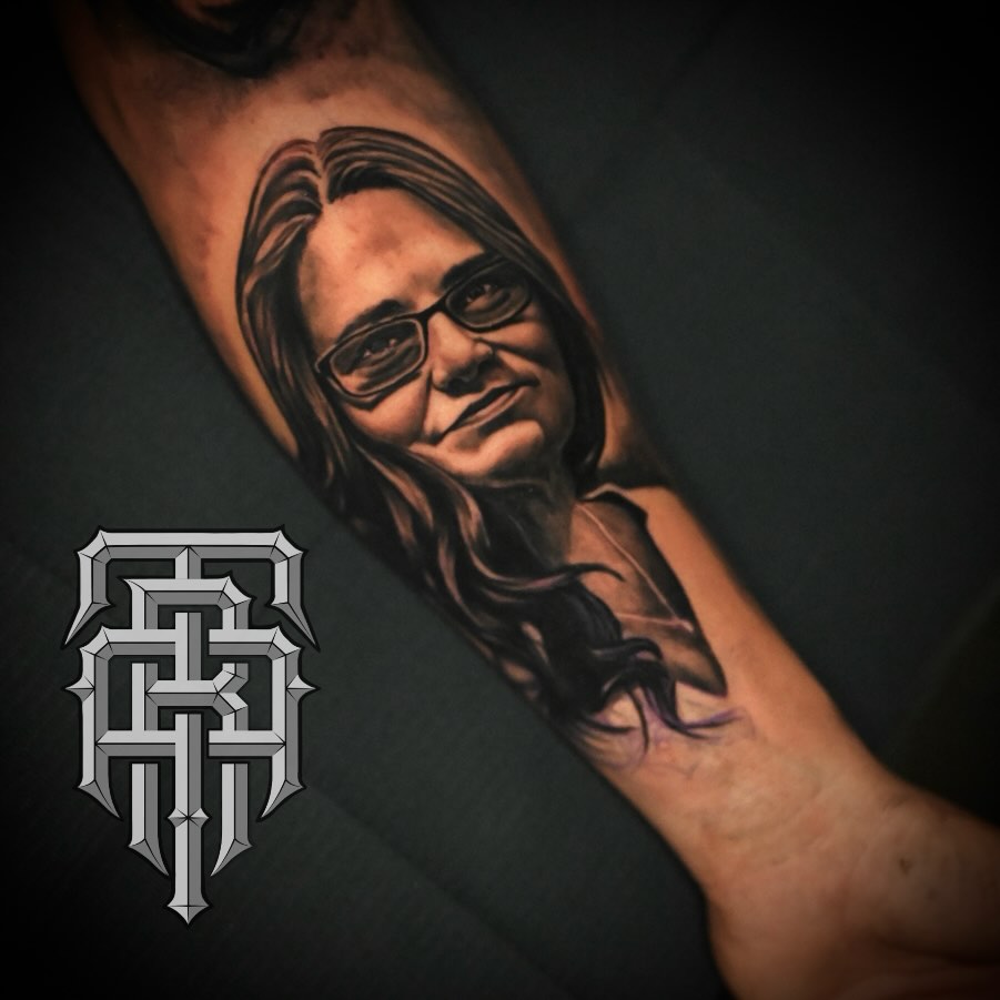 Portrait realism tattoo on the forearm by Art Lopez