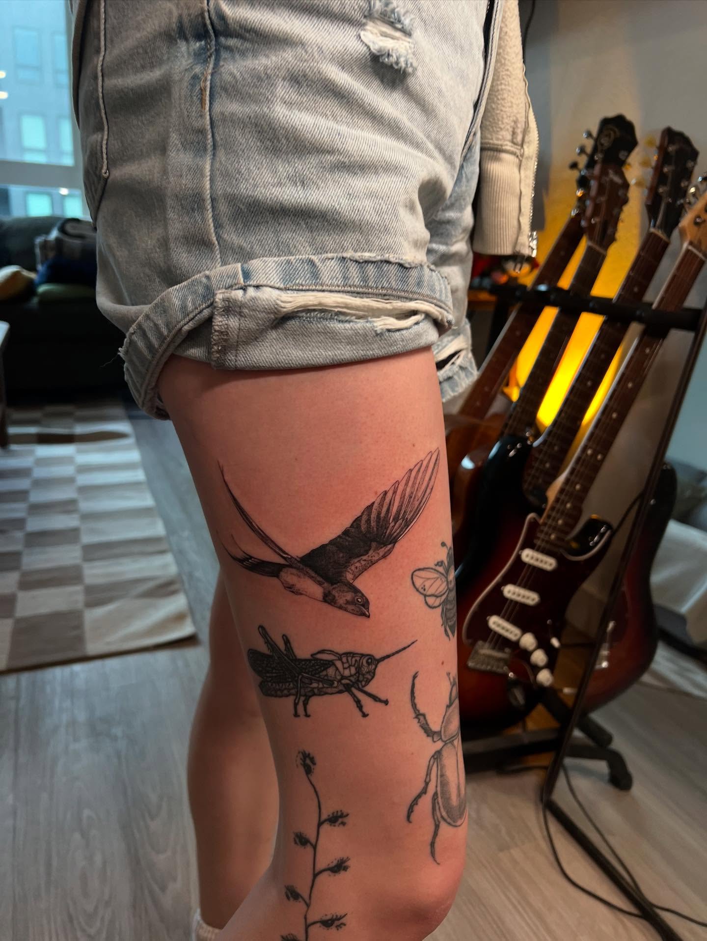Insects and plant black and grey tattoo on the thigh by sarah bug