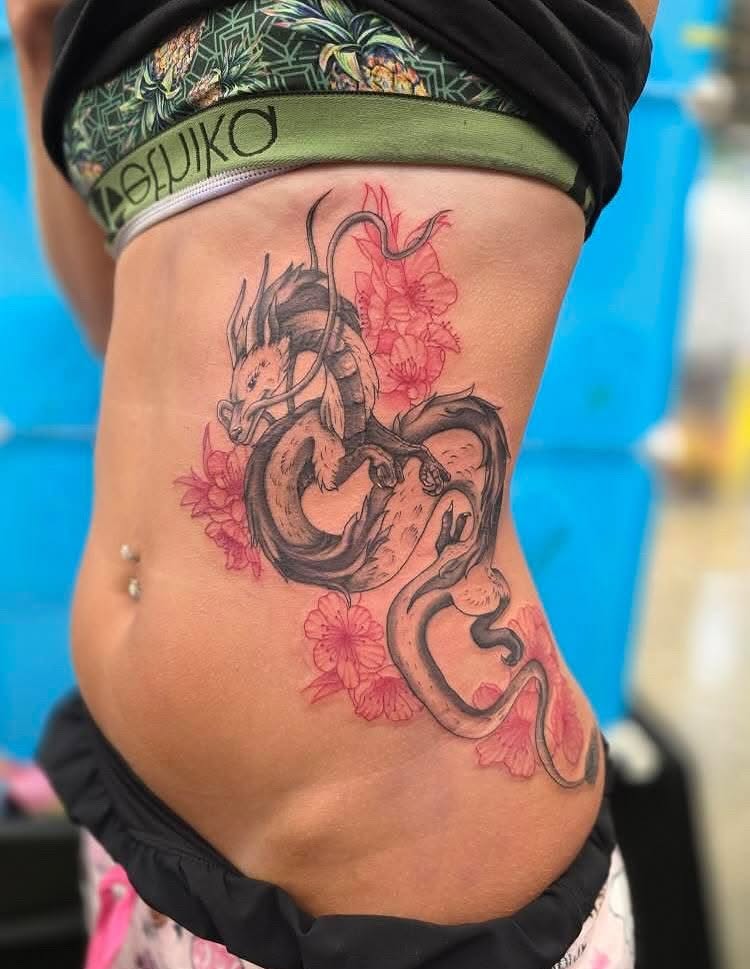 Dragon and flowers new school tattoo on the ribs by Claudia Isabel Roman, El Paso, Texas