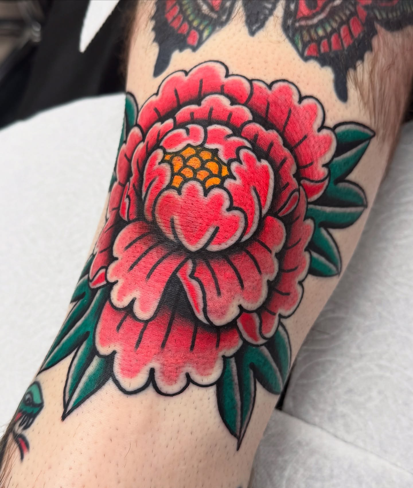 Peony American traditional tattoo on the forearm by Joey Burdette Tattoos