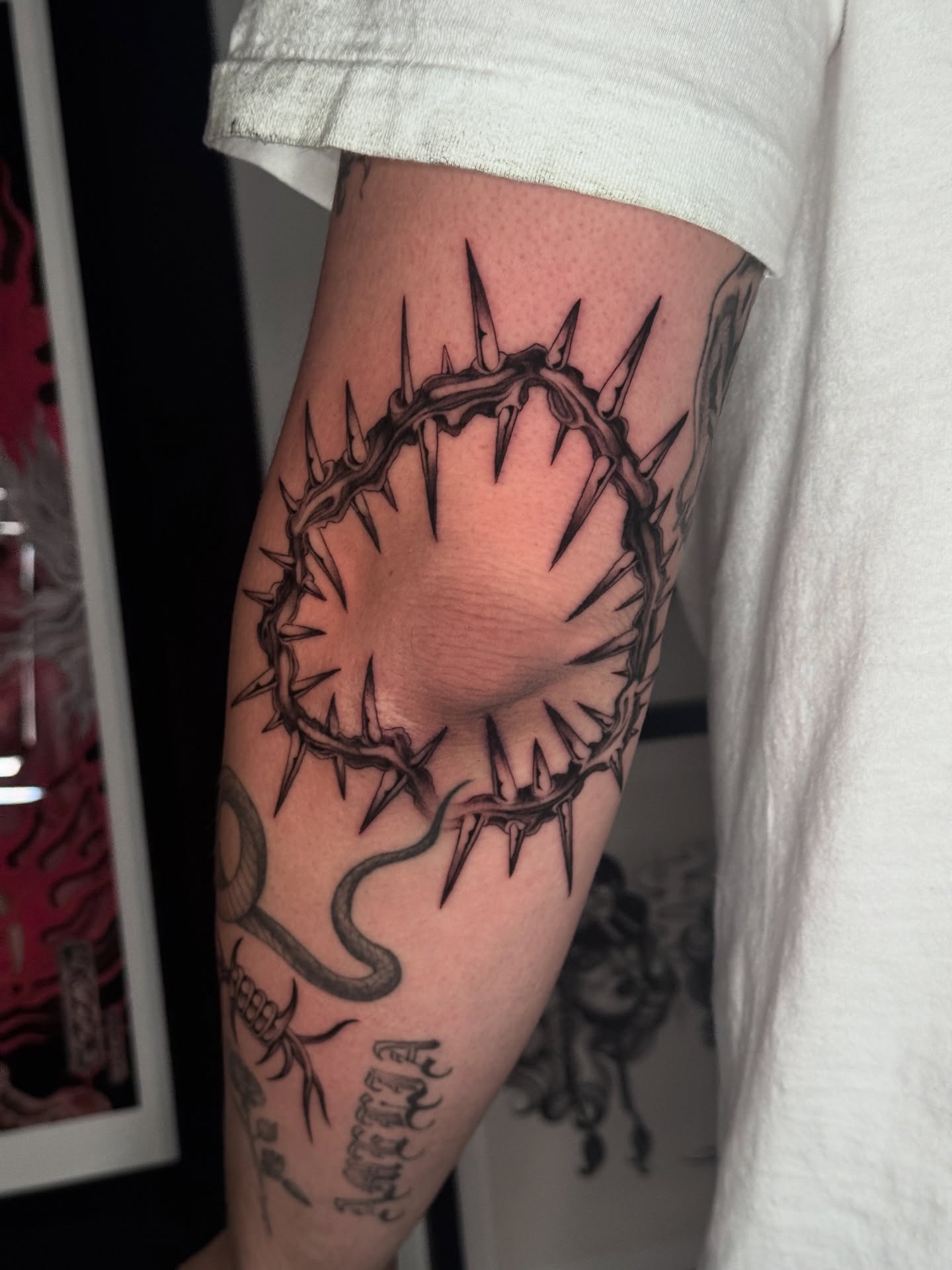 Crown of thorns black and grey tattoo on the forearm by ella