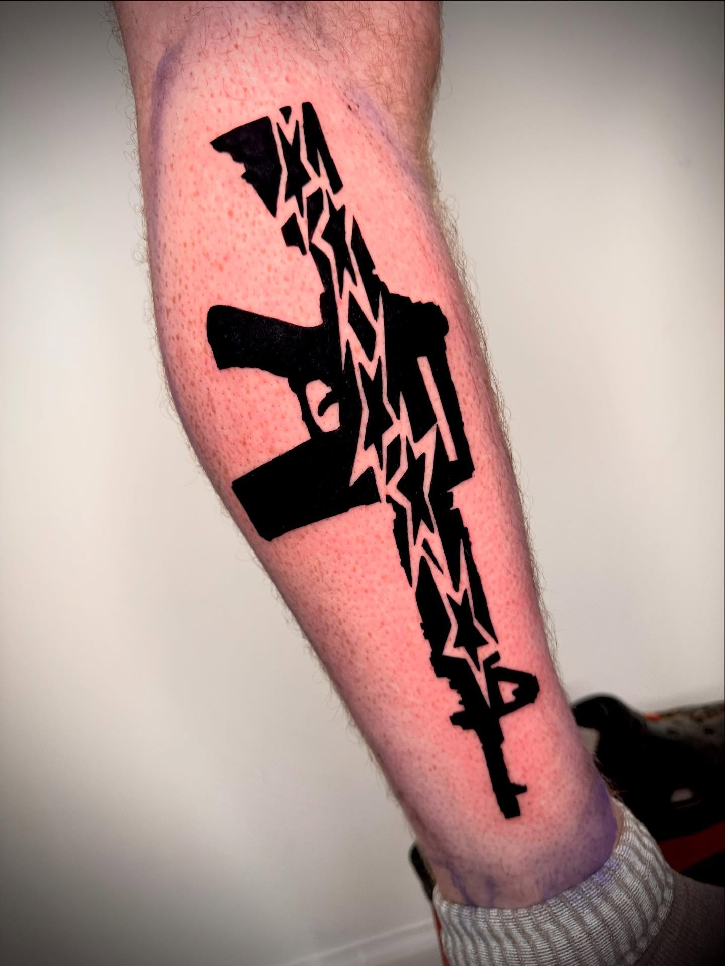 Machine gun black and grey tattoo on the forearm by 𝔠𝔲𝔯𝔱𝔦𝔰 ~ tattoo artist