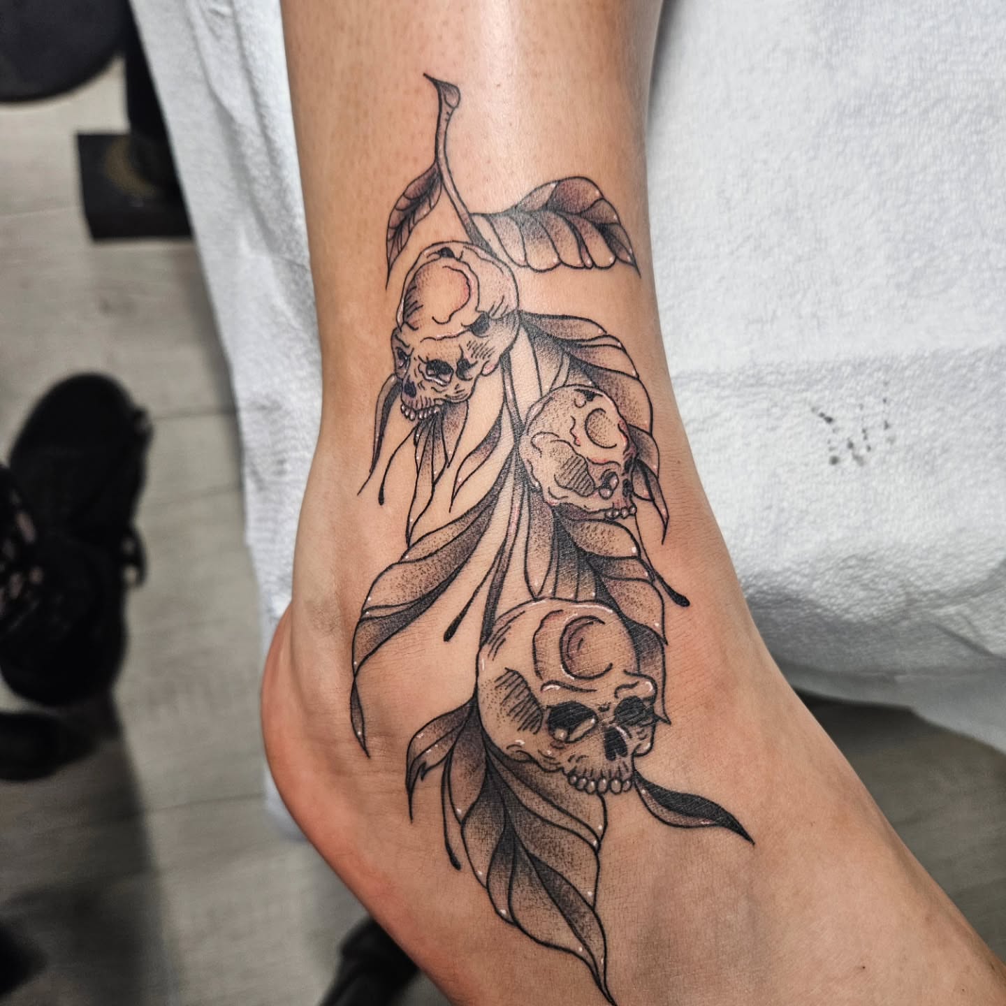 Skulls and leaves dotwork tattoo on the foot by Ari🖤