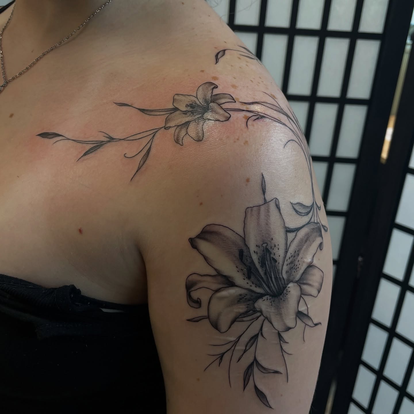 Lily black and grey tattoo on the shoulder by kaylee