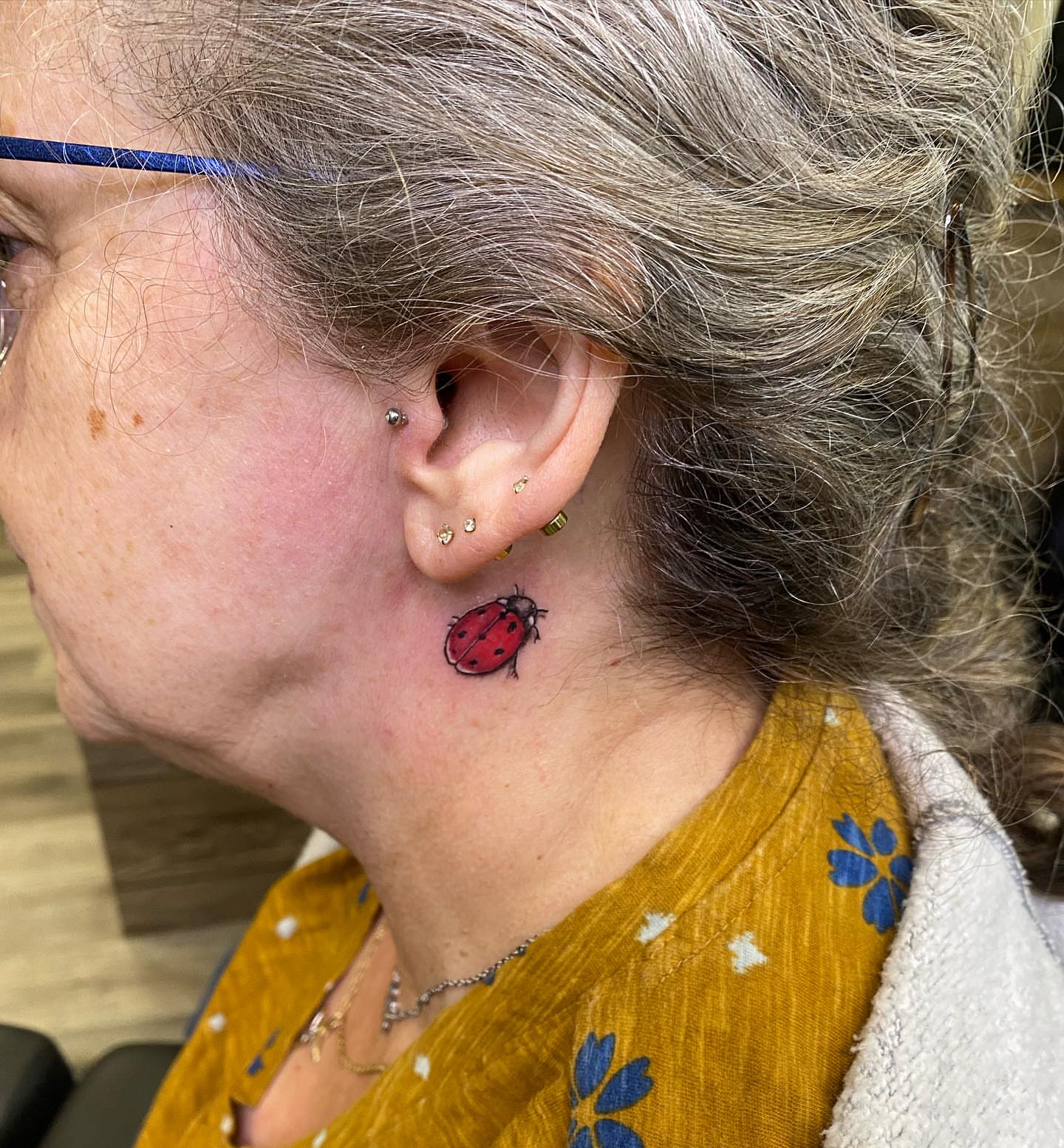 Ladybug realism tattoo on the neck by Spencer Jones Tattoos