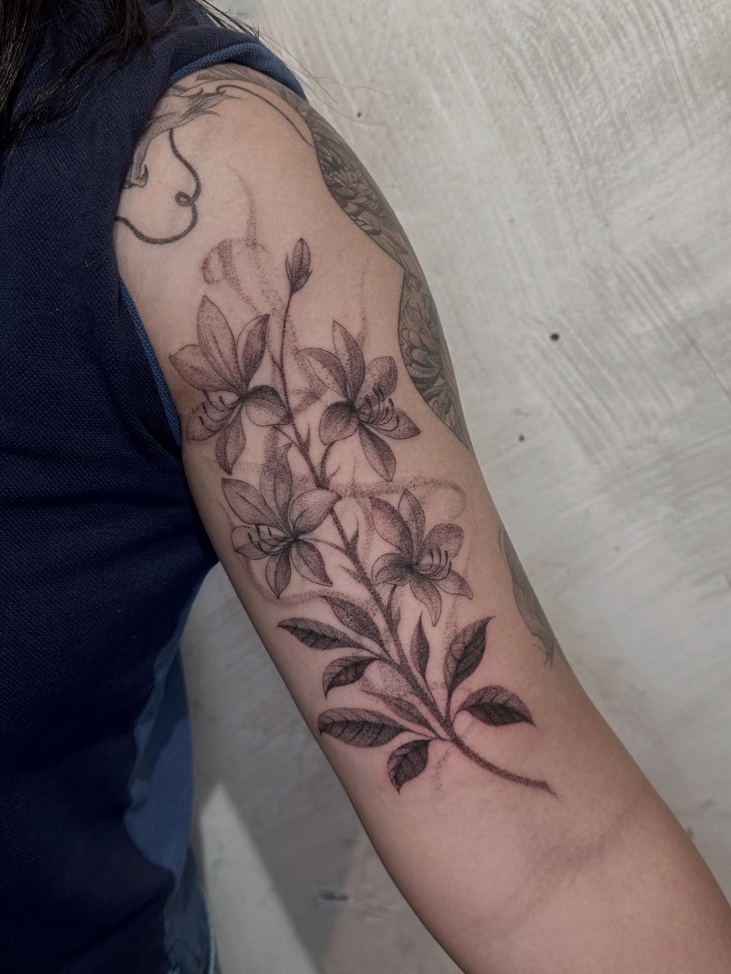 Lily flowers dotwork tattoo on the forearm by Arhem Quiambao