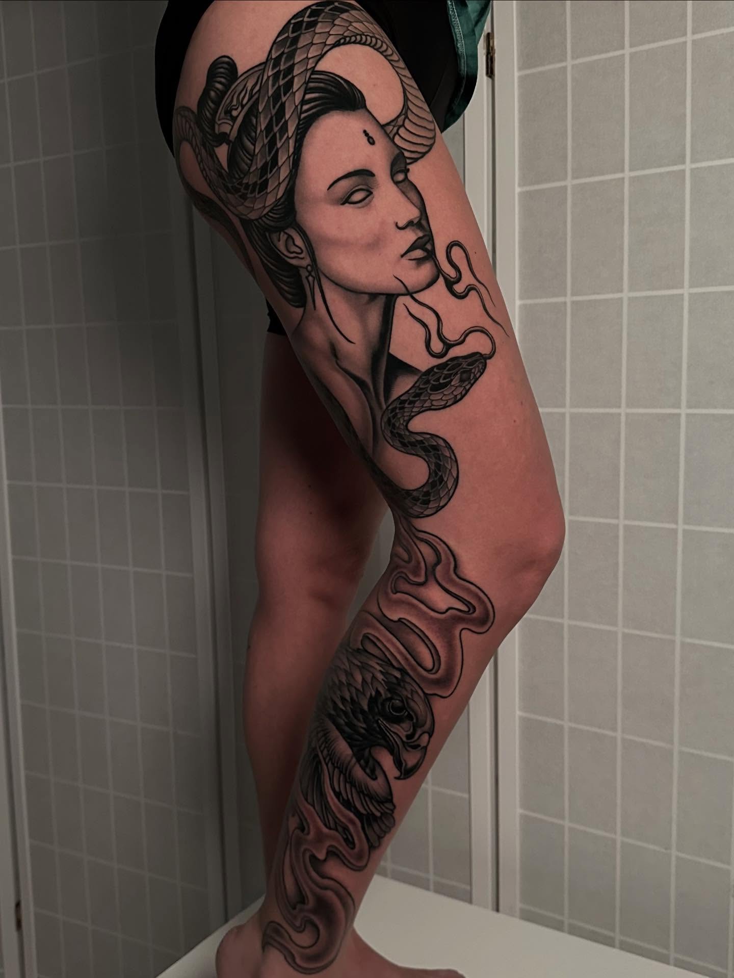 Woman with snake realism tattoo on the forearm by Henry Gaßner