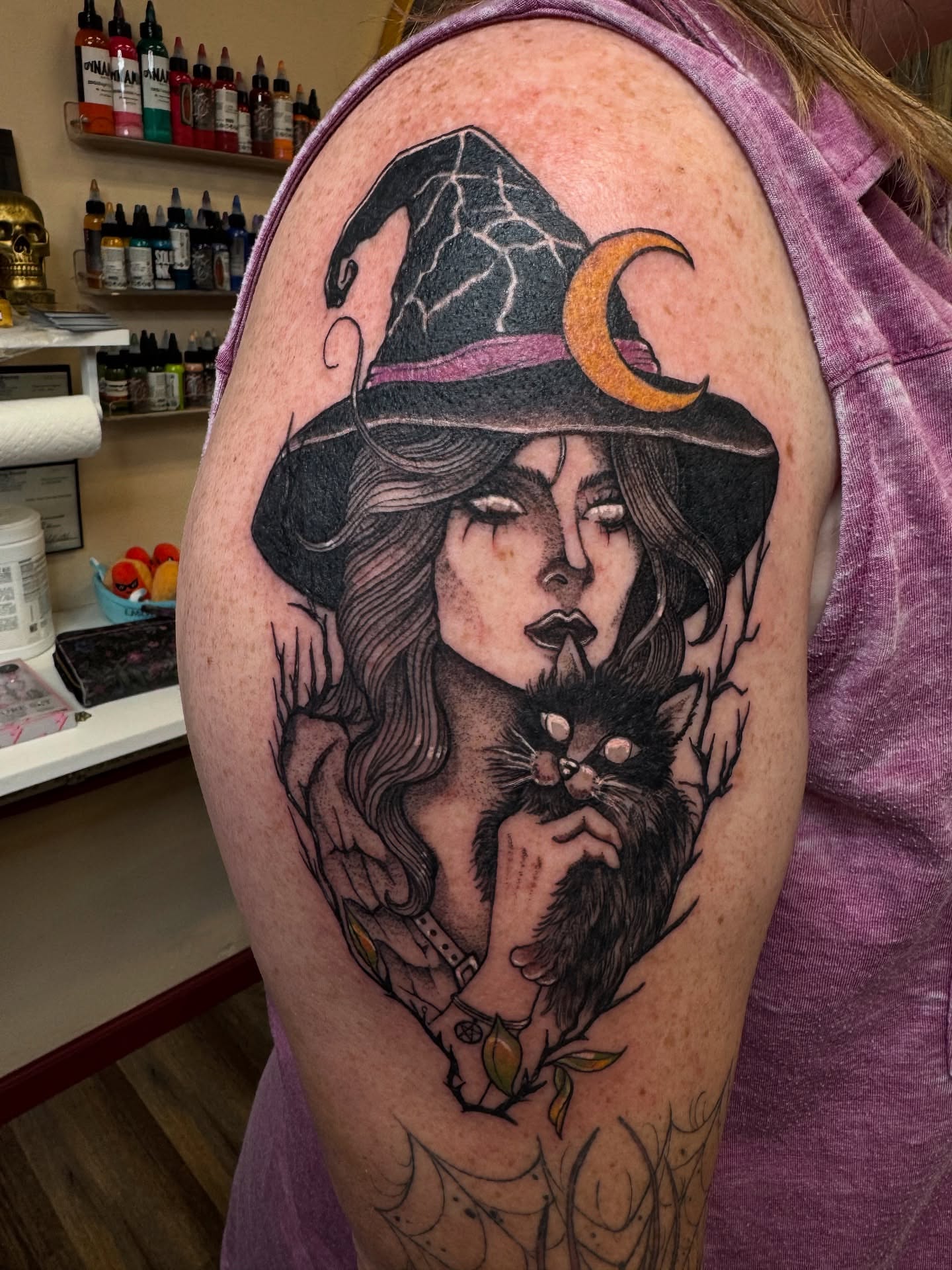 Witch and cat realism tattoo on the shoulder by Erin Moore