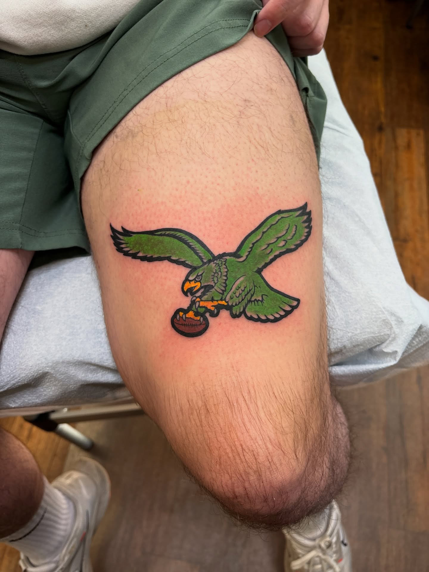Flying eagle American traditional tattoo on the thigh by Mike DiCicco
