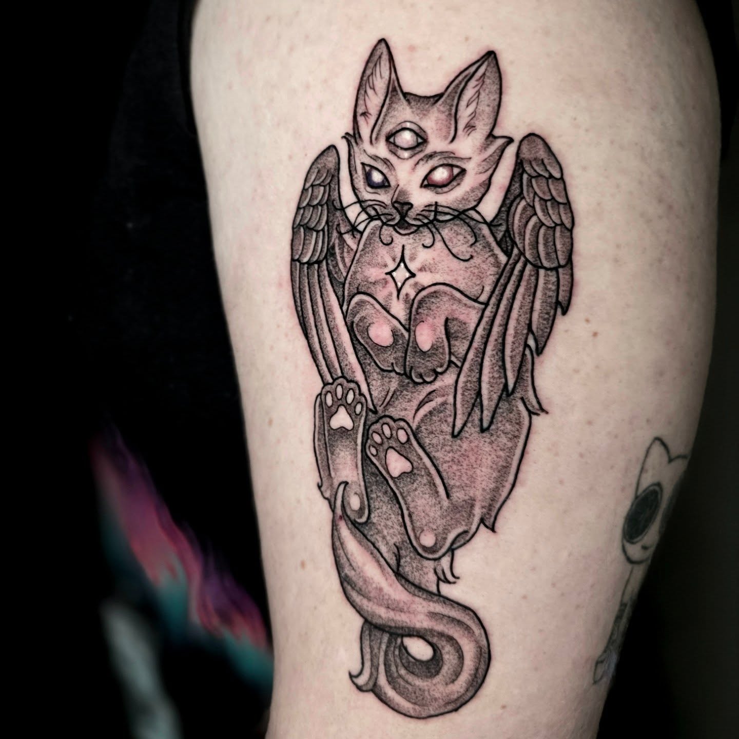 Cat with wings dotwork tattoo on the thigh by Adison Essig