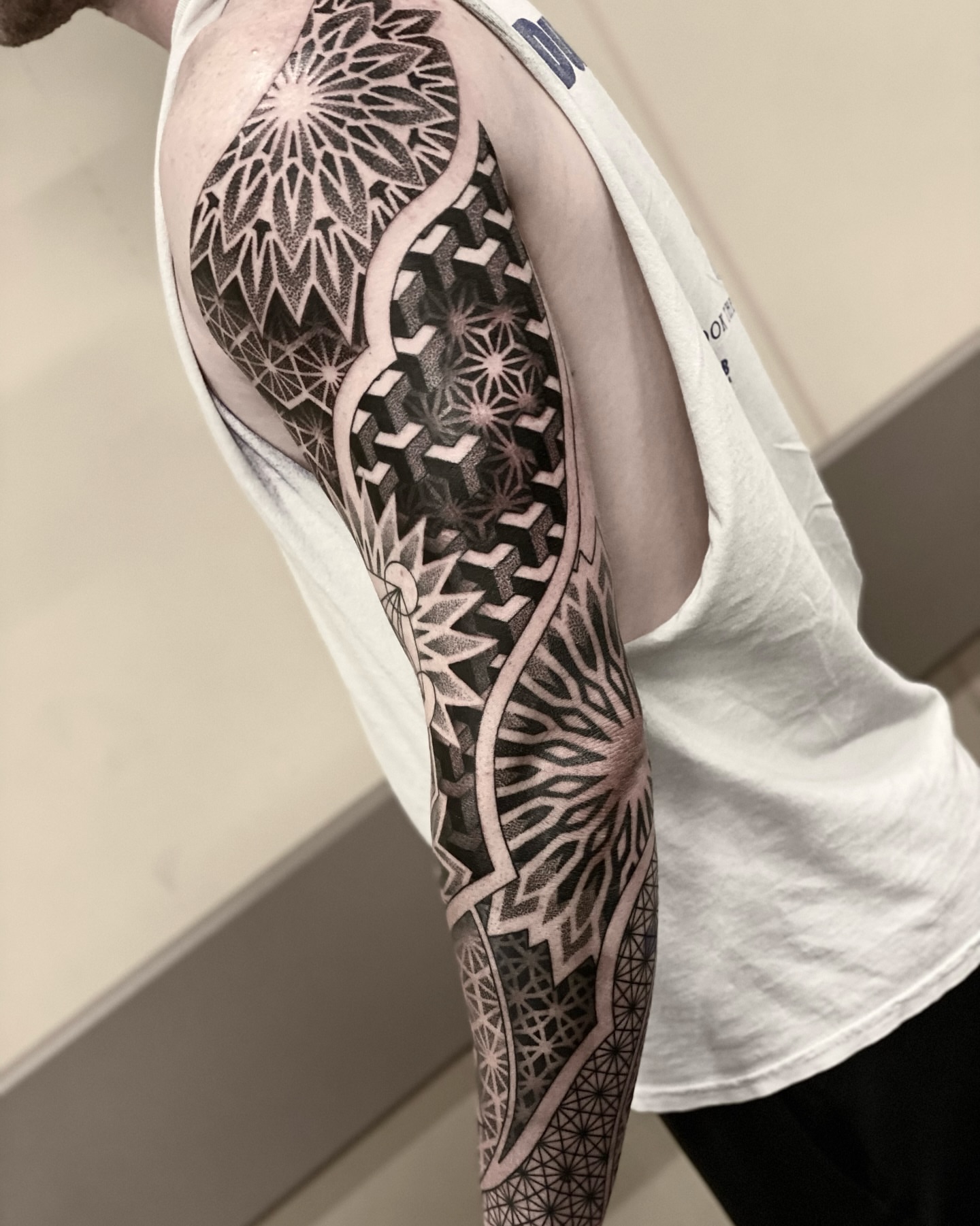 Geometric patterns geometric tattoo on the upper arm by Nick Fierro