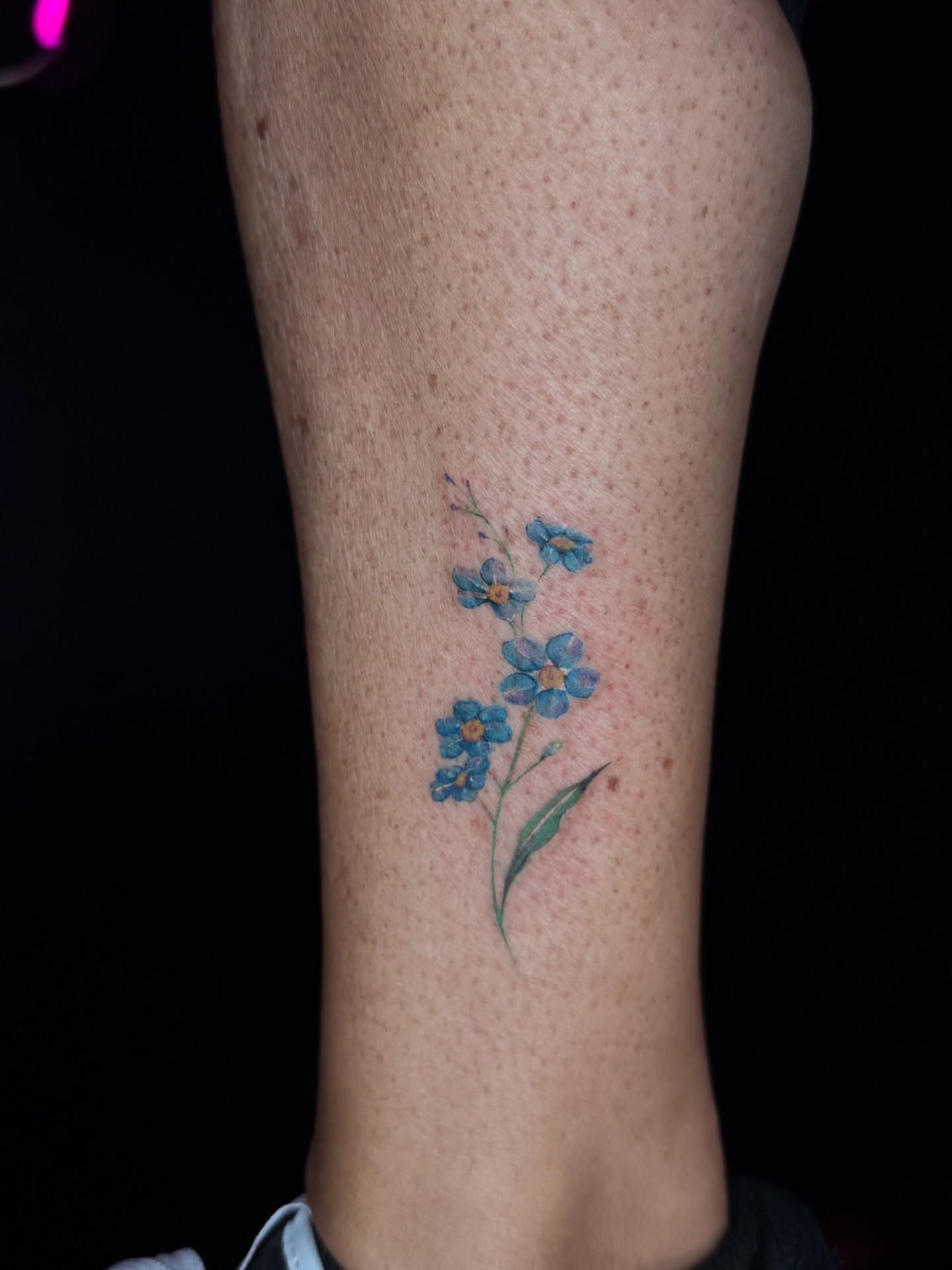 Blue forget-me-not flowers watercolor tattoo on the forearm by B o n d B o n d , “ a r t i s t “