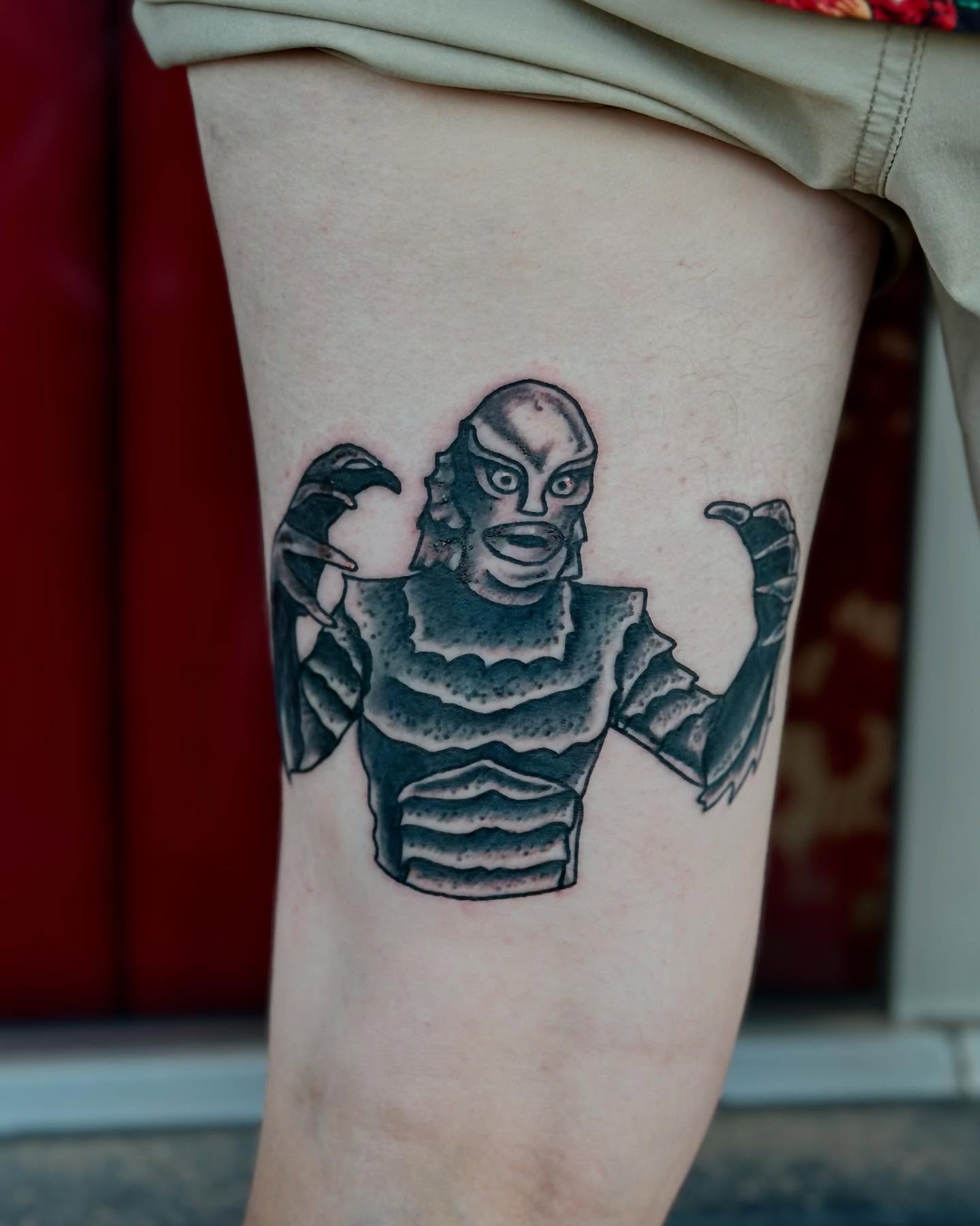 Creature from the Black Lagoon black and grey tattoo on the thigh by Brooke