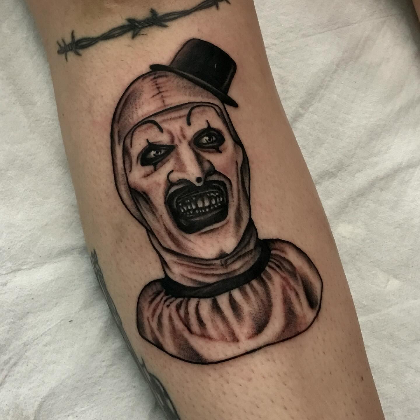 Clown realism tattoo on the forearm by Lee Brewster, Erlanger, Kentucky