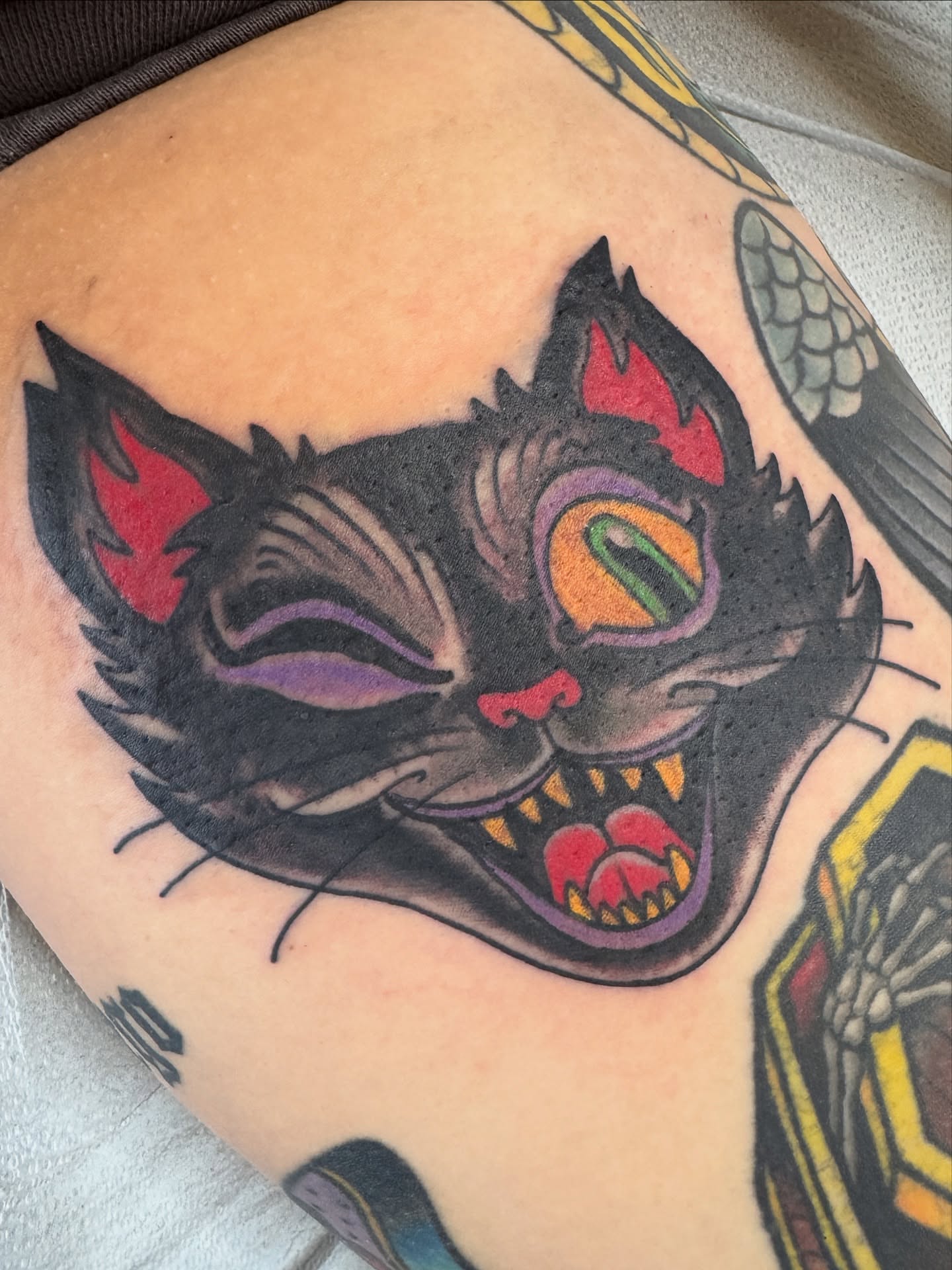 Cat American traditional tattoo on the thigh by Cary Aldridge