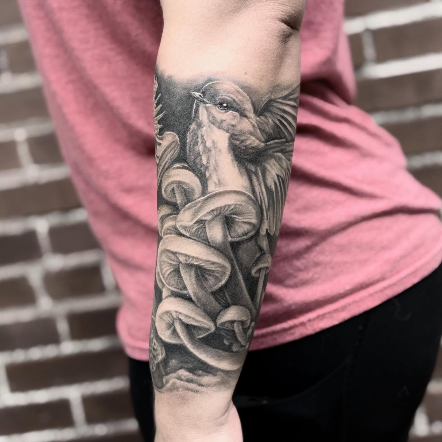Bird and mushrooms realism tattoo on the forearm by Blake Van Vleck