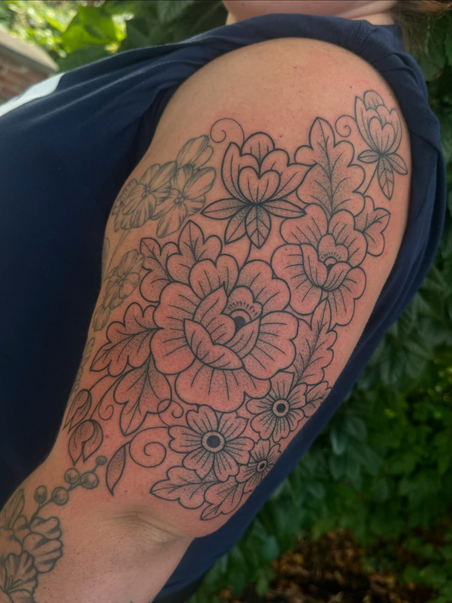 Floral bouquet black and grey tattoo on the upper arm by ꧁꧁Hayley꧂꧂