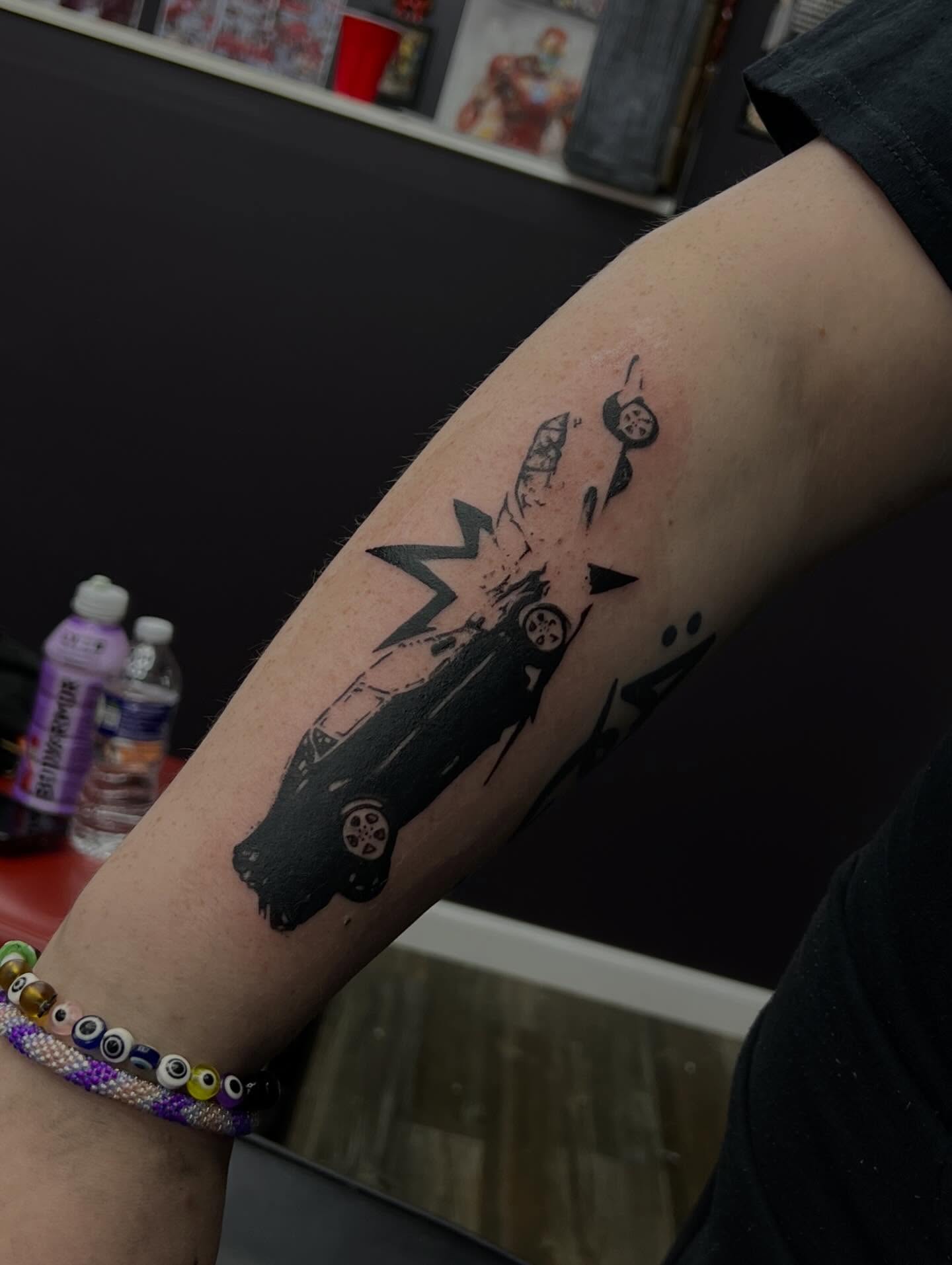 Car crash black and grey tattoo on the forearm by ★𝐑𝐮𝐞★