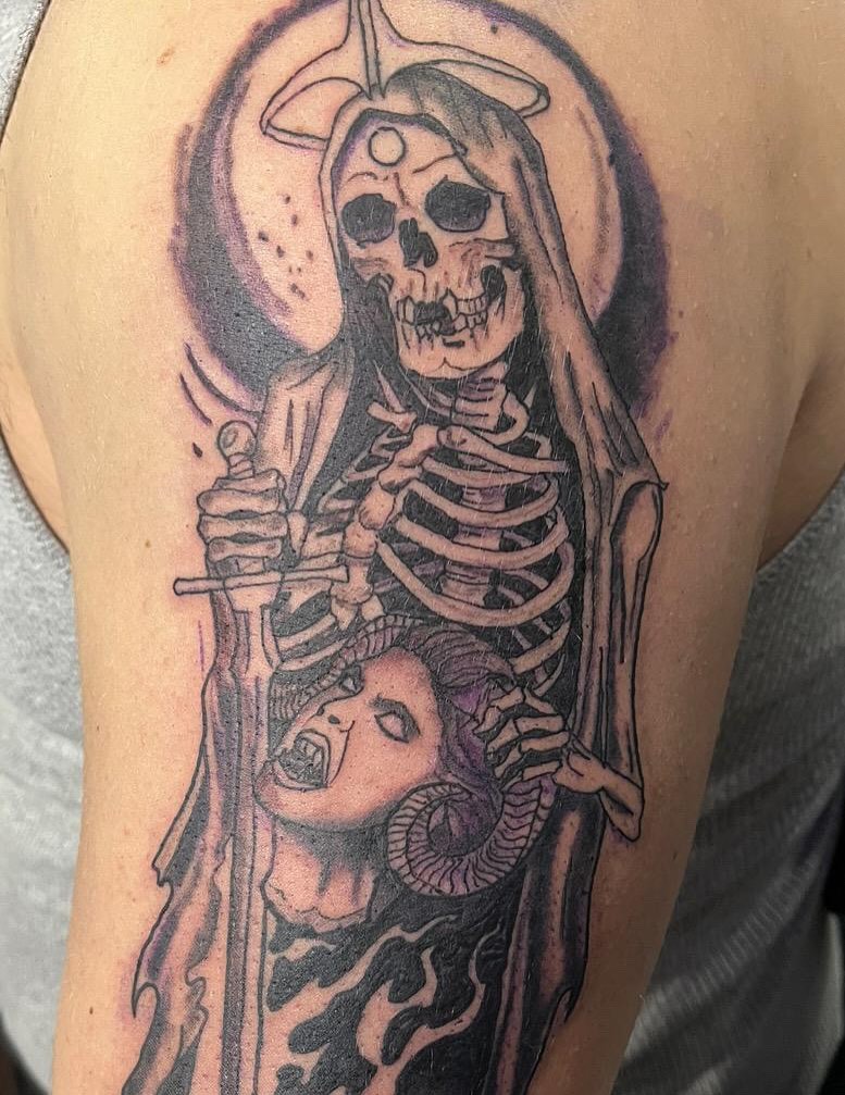 Skeleton holding woman realism tattoo on the shoulder by Eddie Cesena