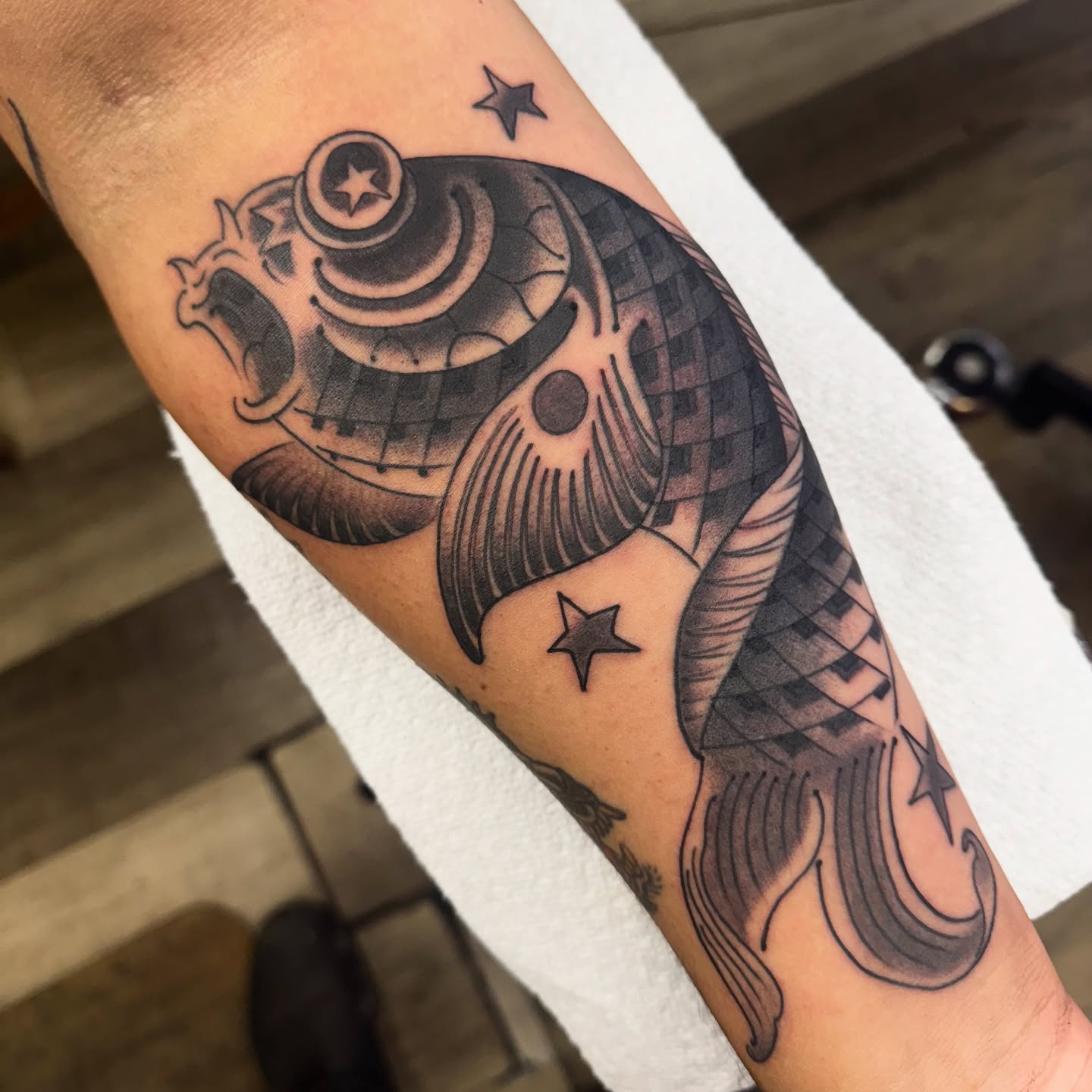 Koi fish black and grey tattoo on the forearm by Chris Orta