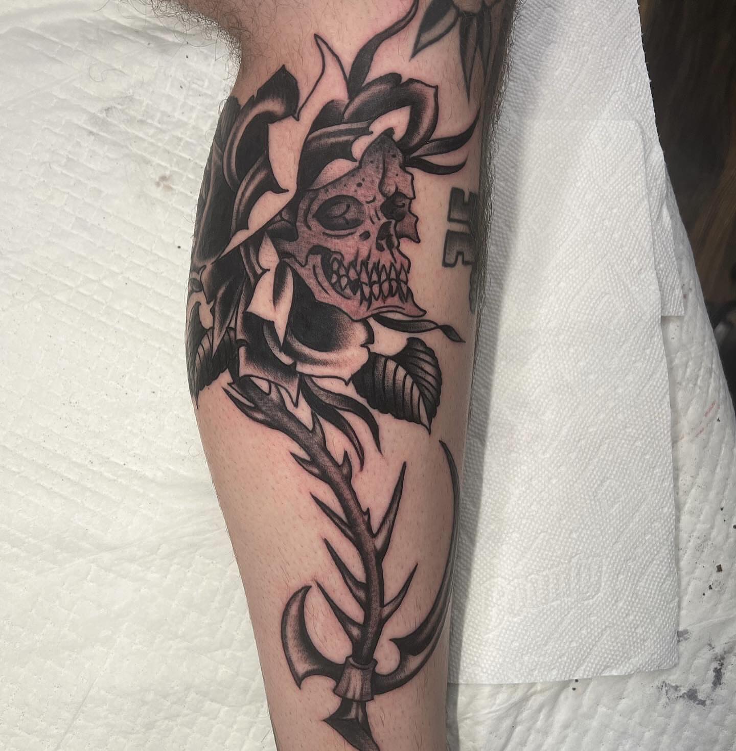 Skull and anchor dark realism tattoo on the forearm by Matt E.