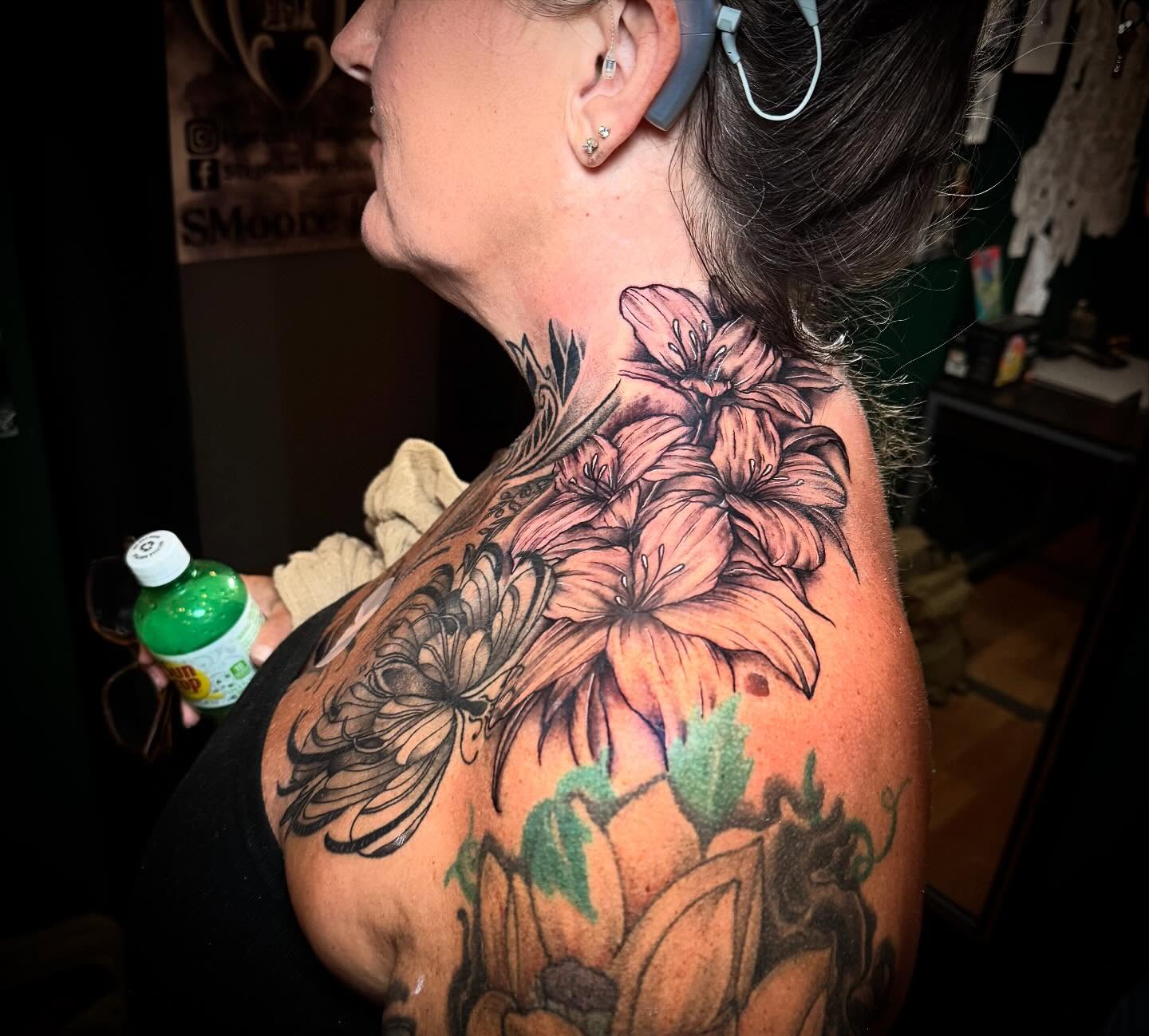 Floral bouquet realism tattoo on the shoulder by Jeremy Carson