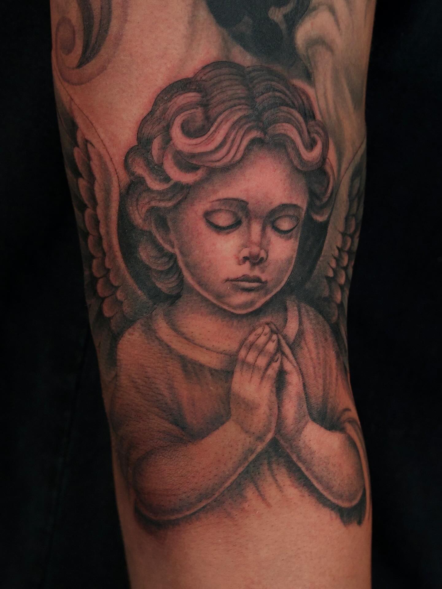Praying angel realism tattoo on the forearm by Chris Lochbihler