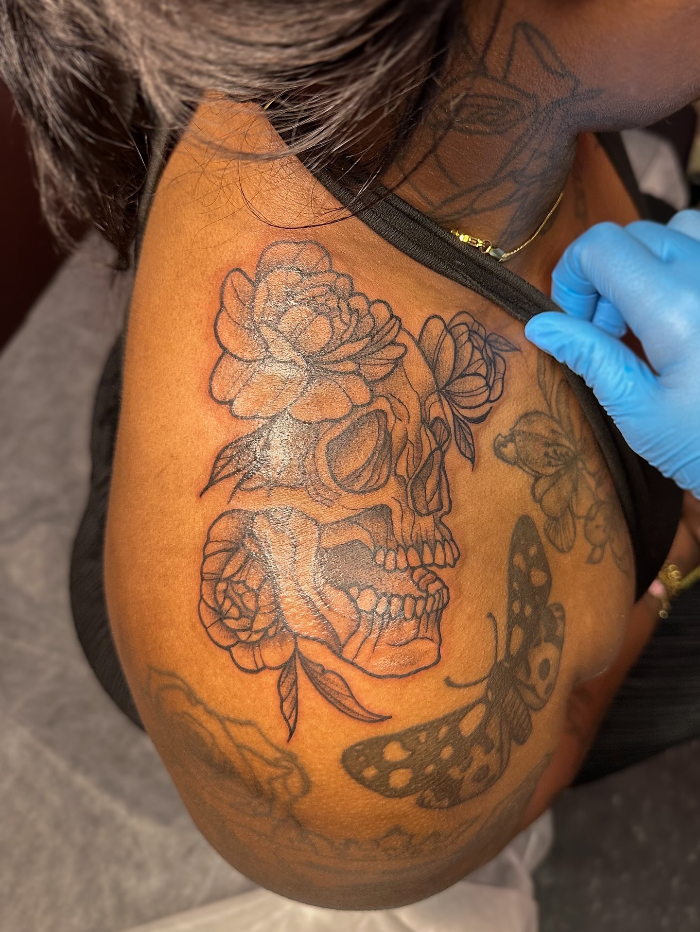 Skull and flowers black and grey tattoo on the shoulder by π·πππ, Cleveland, Ohio