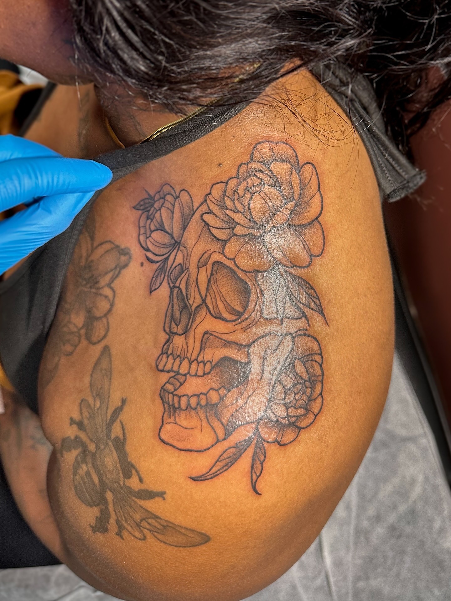 Skull with flowers black and grey tattoo on the shoulder by π·πππ, Cleveland, Ohio