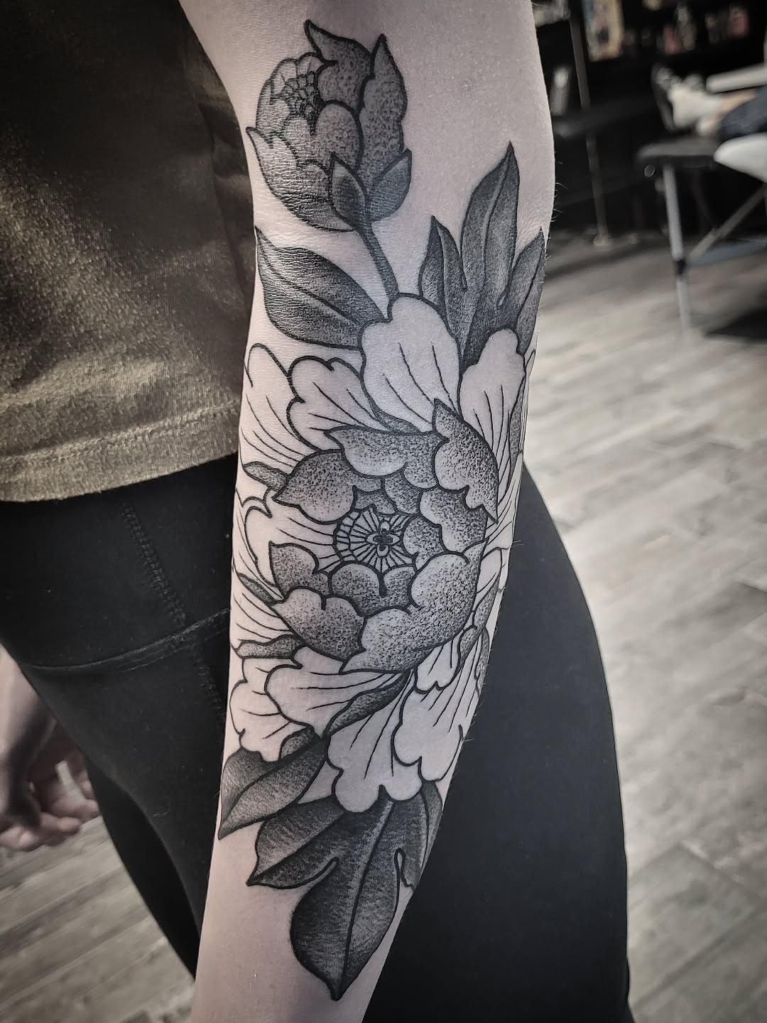 Floral arrangement dotwork tattoo on the forearm by Kirk George