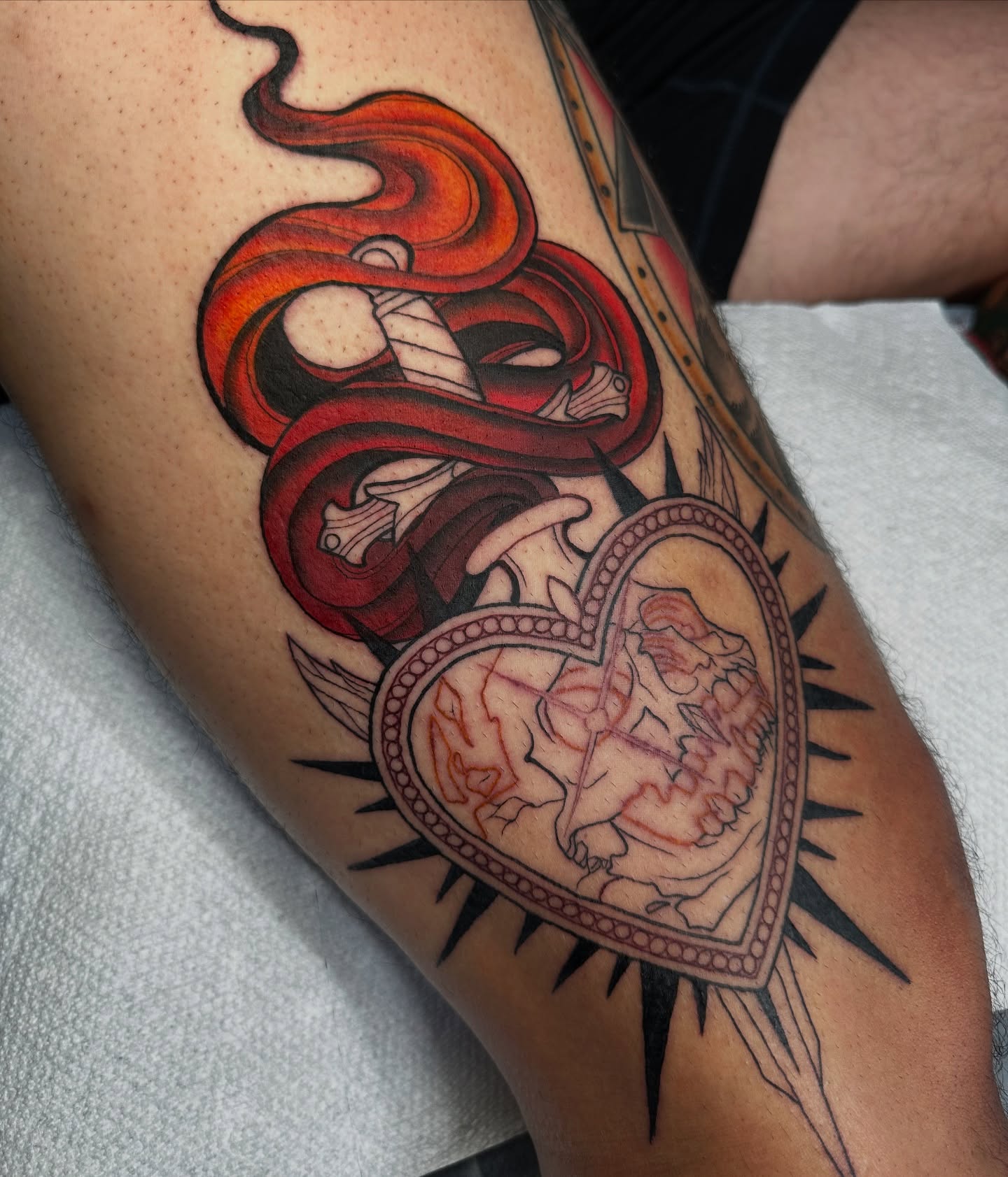 Heart with snake neo-traditional tattoo on the forearm by Taylin Johnson- Illustrative Blackwork, Columbus, Ohio