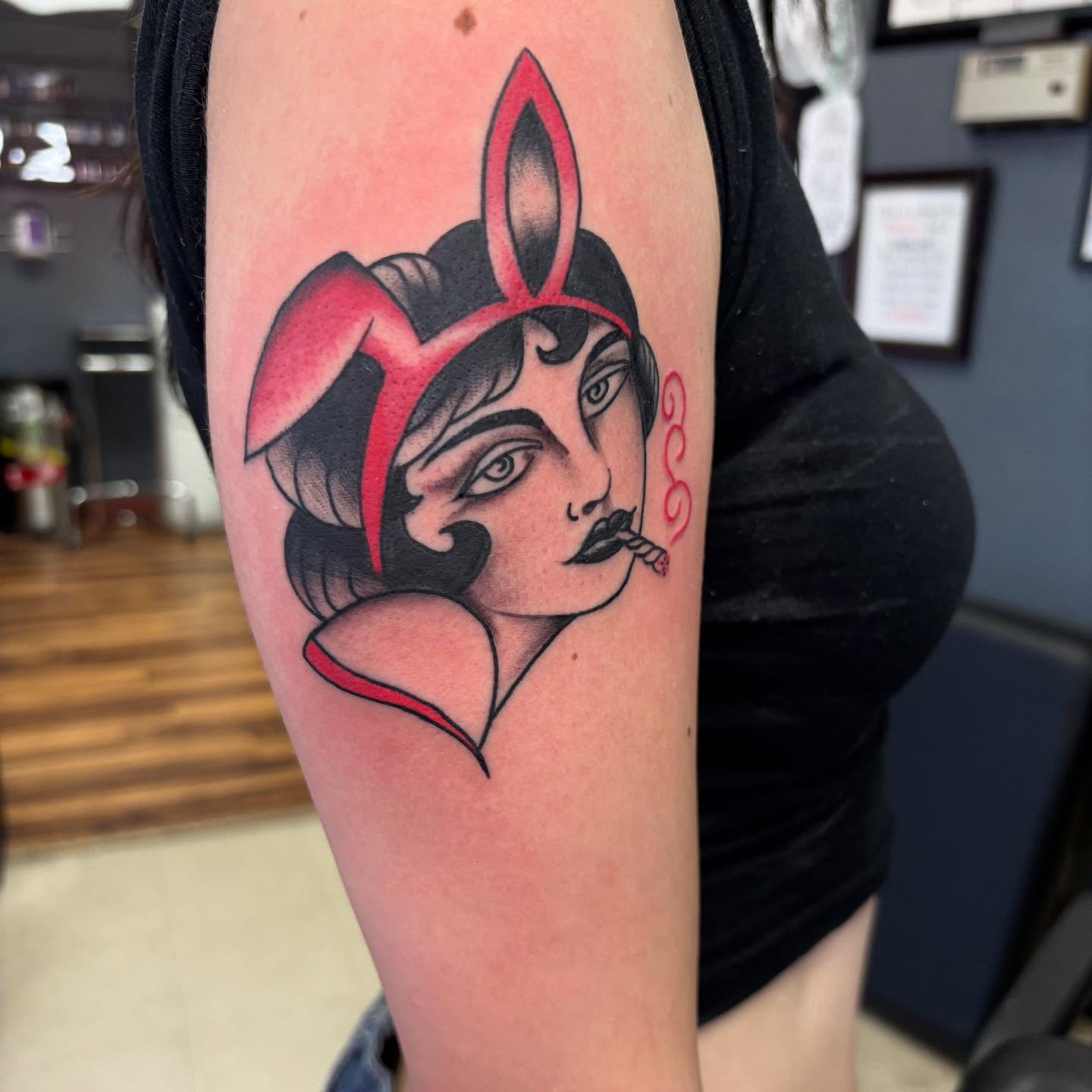 Woman with rabbit ears American traditional tattoo on the forearm by 18 and older High End Tattoo