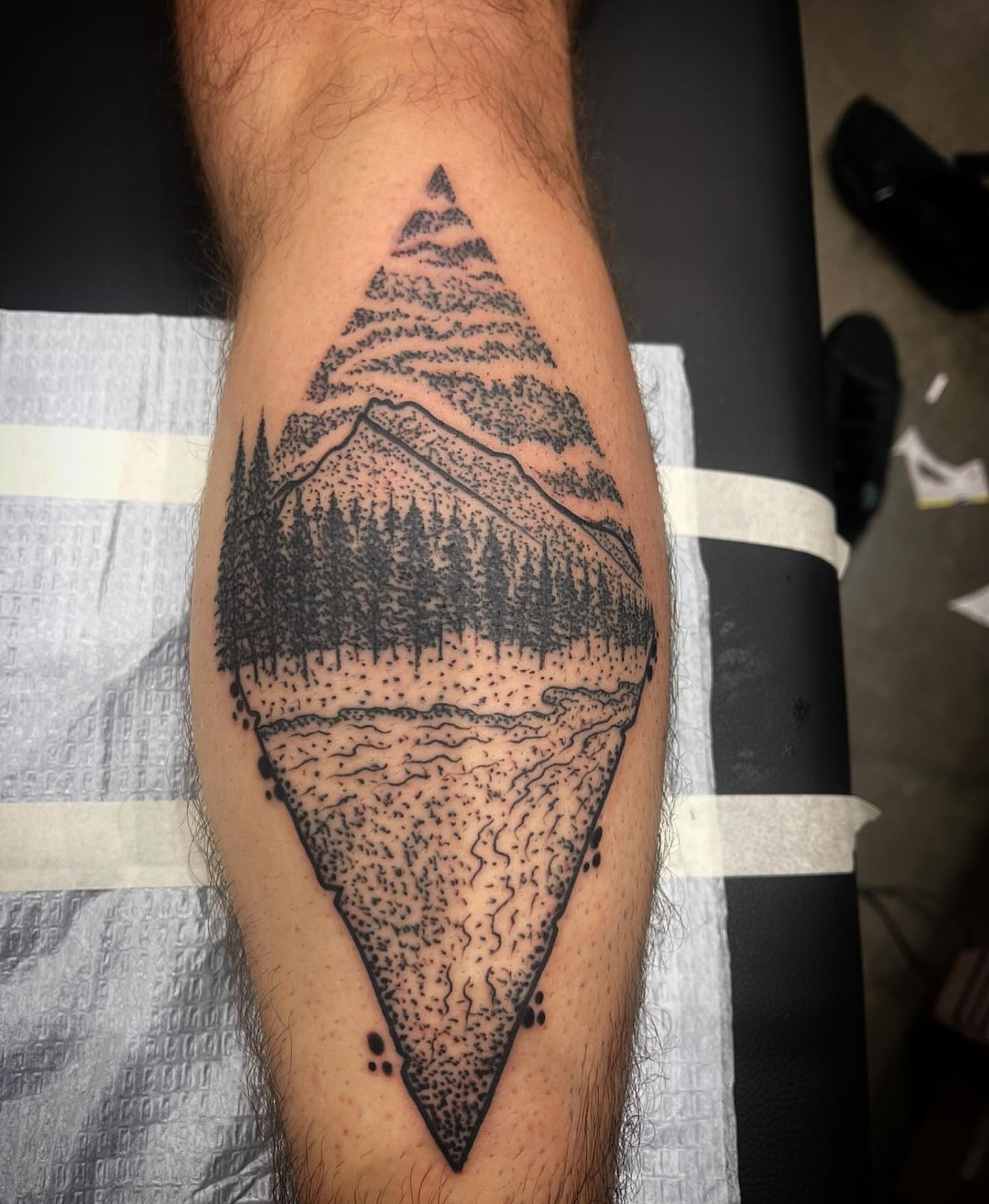 Mountain landscape dotwork tattoo on the forearm by Don Juan