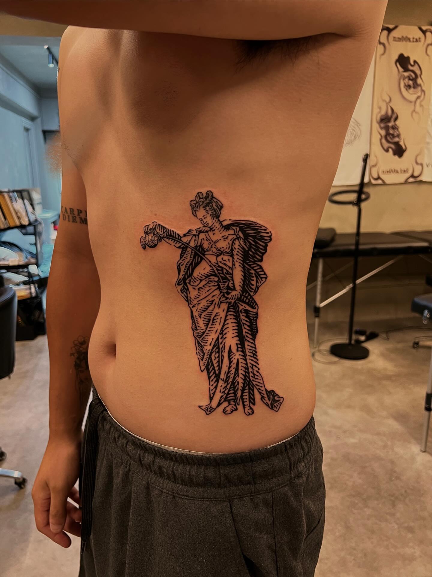 Geisha playing shamisen black and grey tattoo on the ribs by Wonny