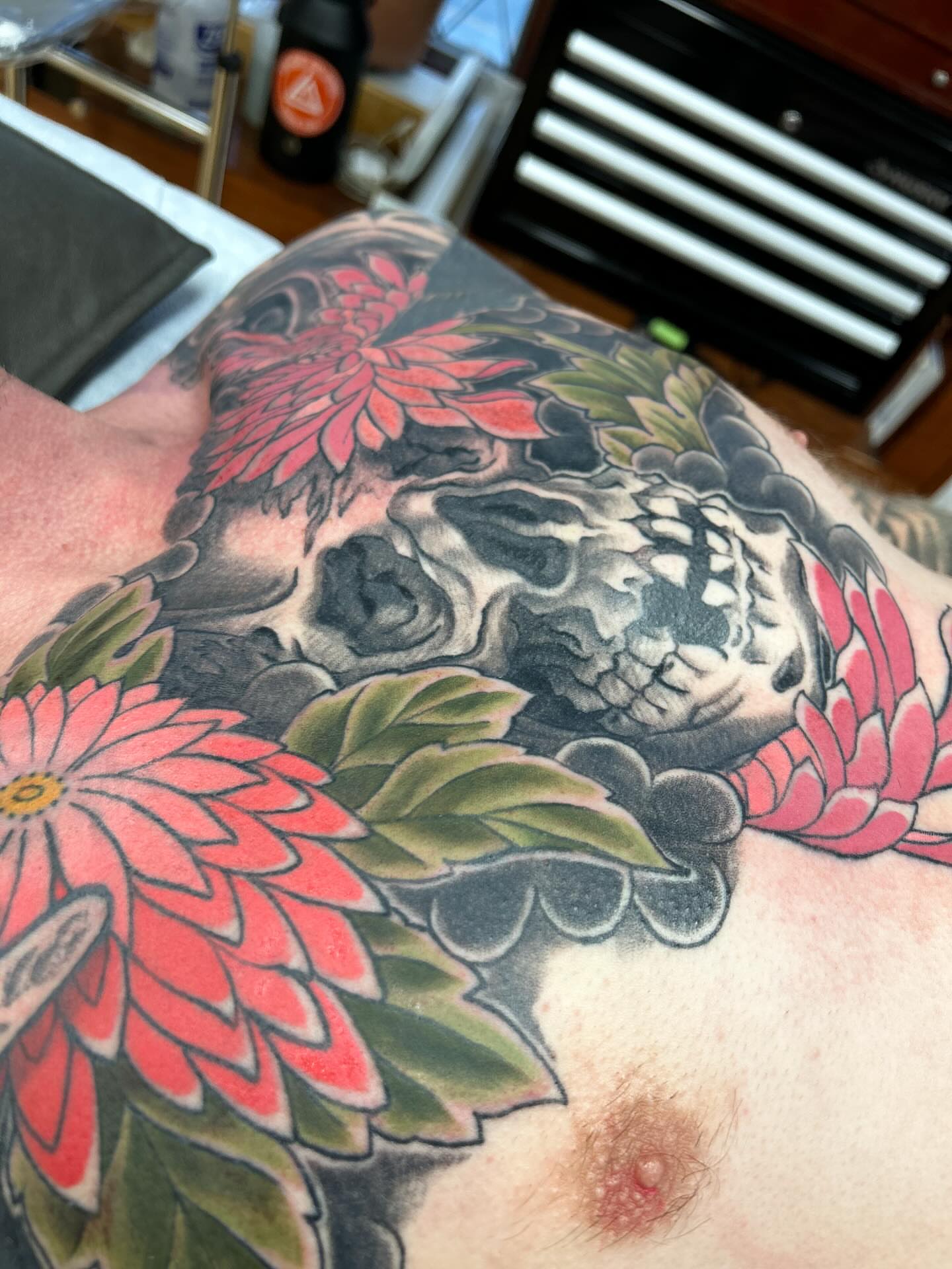Skull and flowers japanese irezumi tattoo on the chest by Matthew Crimson