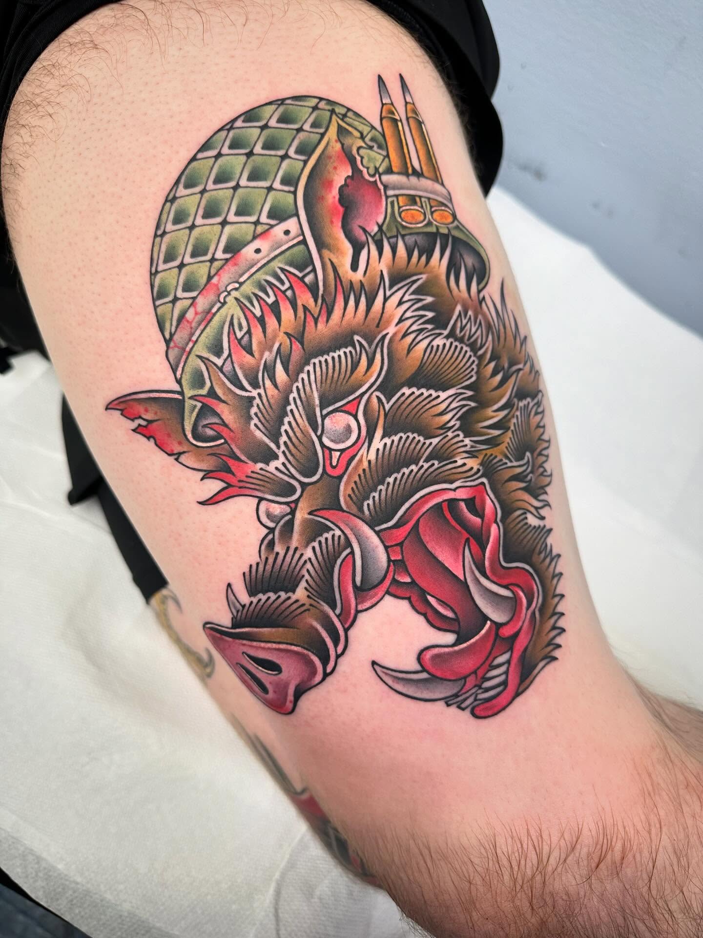 Dragon and helmet American traditional tattoo on the thigh by Mark Boller