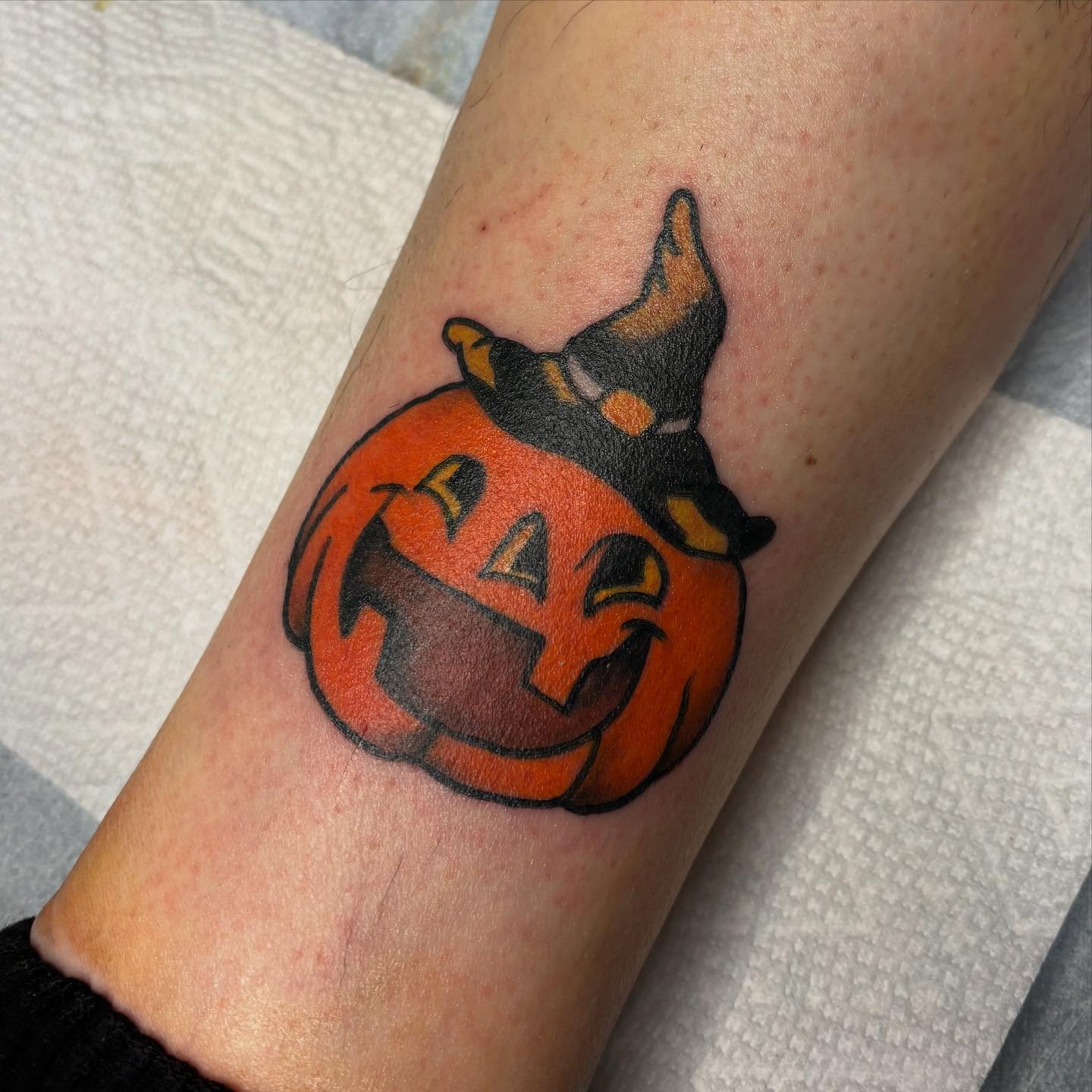 Pumpkin with cat American traditional tattoo on the forearm by Emmy Gallagher
