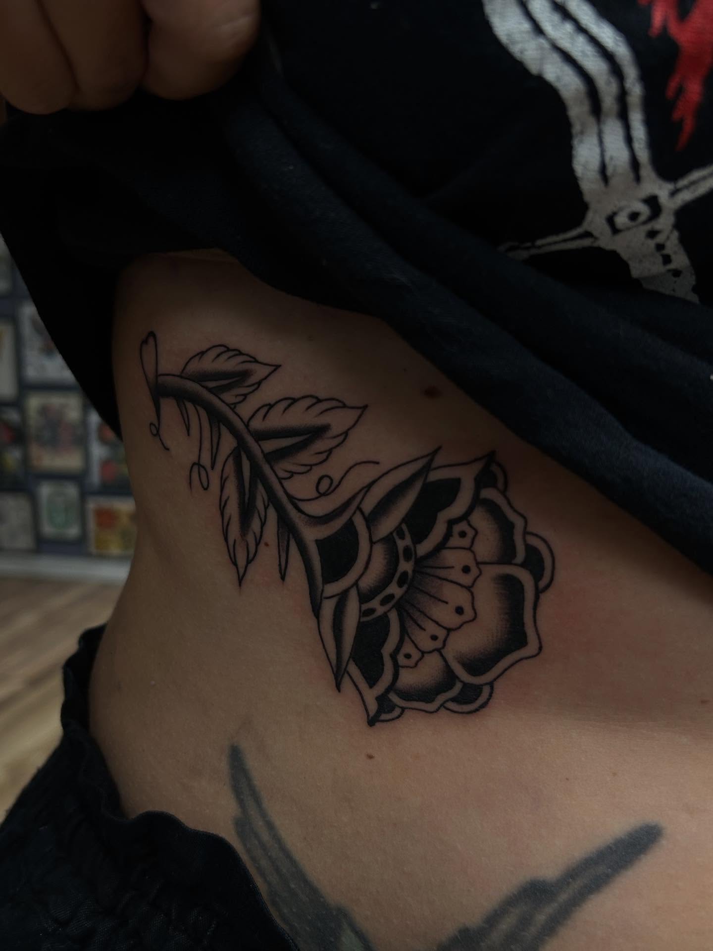 Rose American traditional tattoo on the ribs by Tiffany Vargas