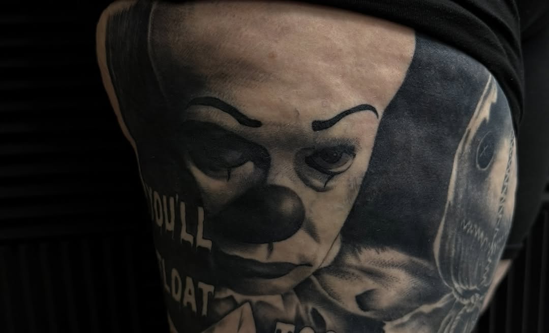Pennywise the clown from IT realism tattoo on the thigh by Nick Campbell