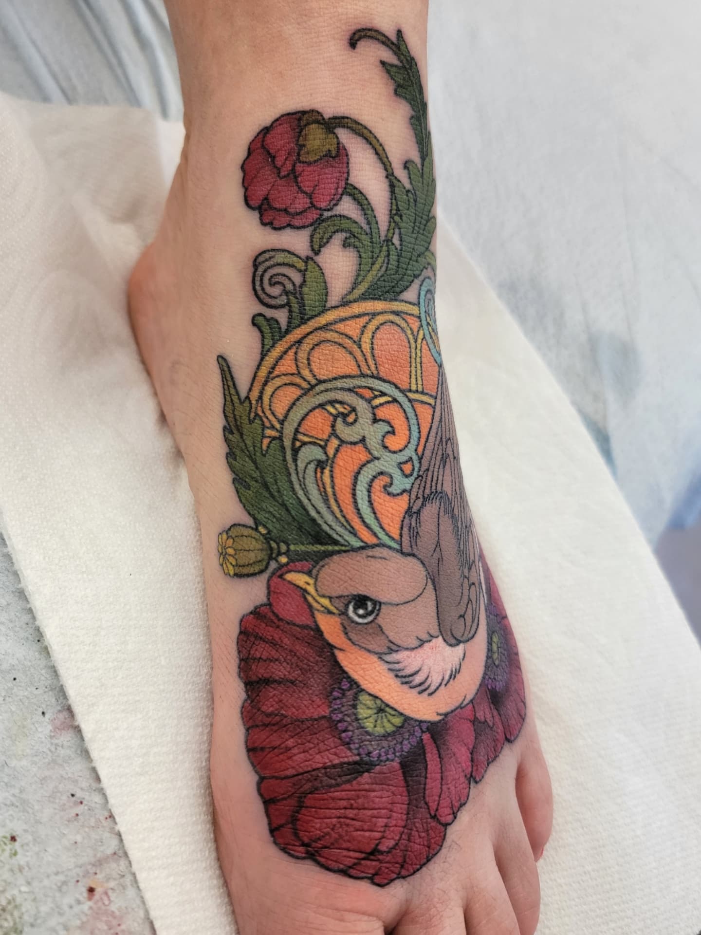 Bird and poppy American traditional tattoo on the foot by Chantel Chan, Portland, Oregon