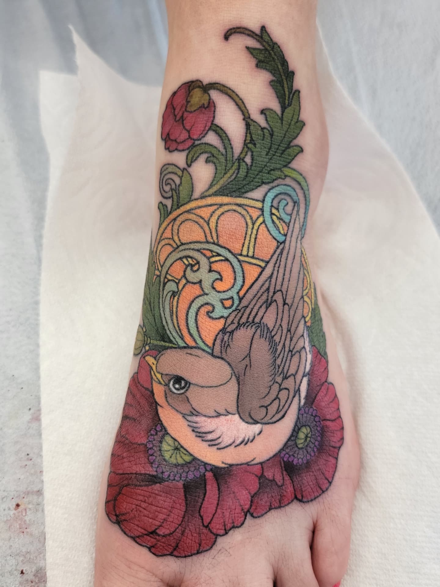 Bird and poppies new school tattoo on the hand by Chantel Chan, Portland, Oregon