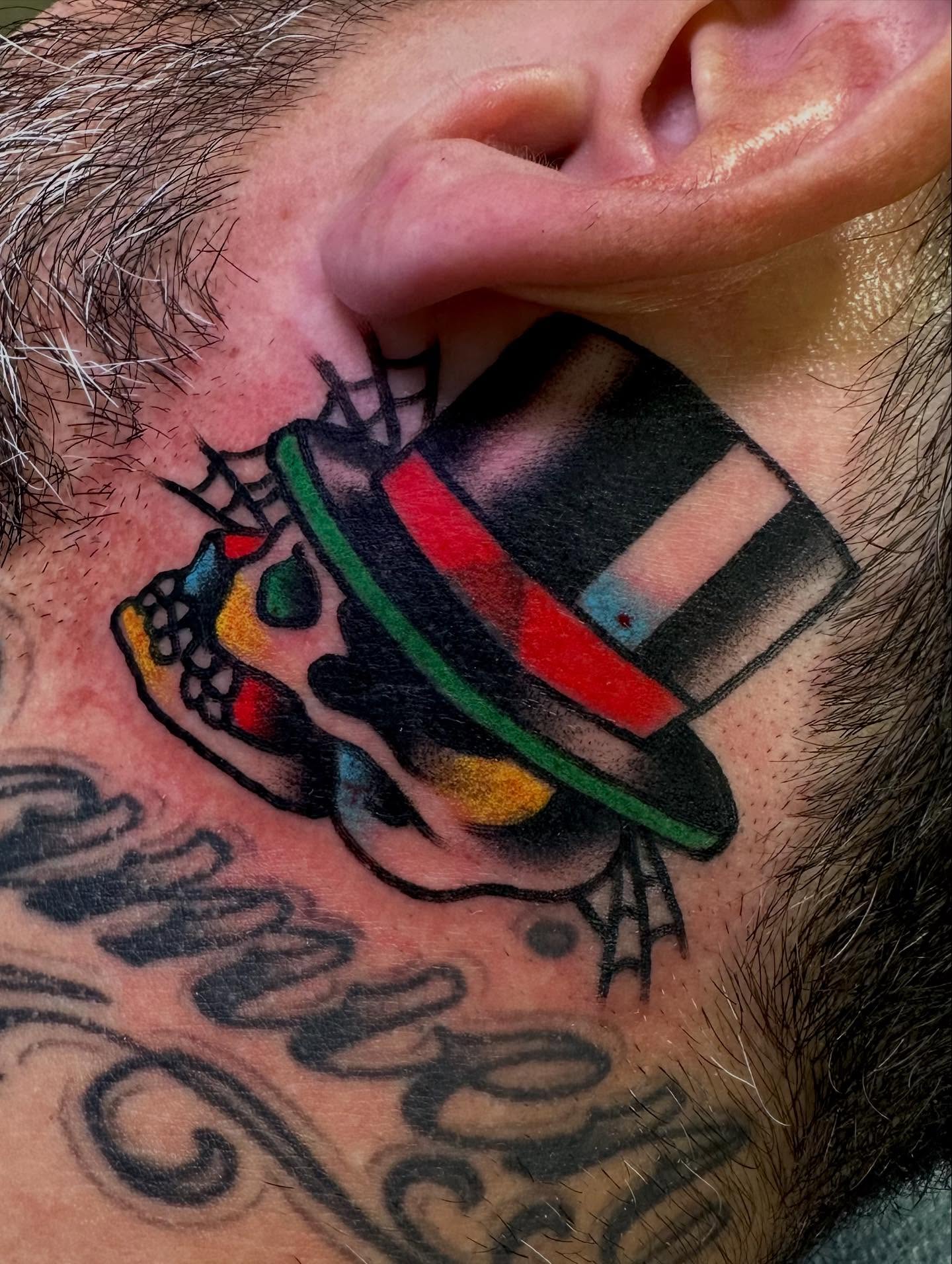 Top hat skull American traditional tattoo on the neck by Dave G