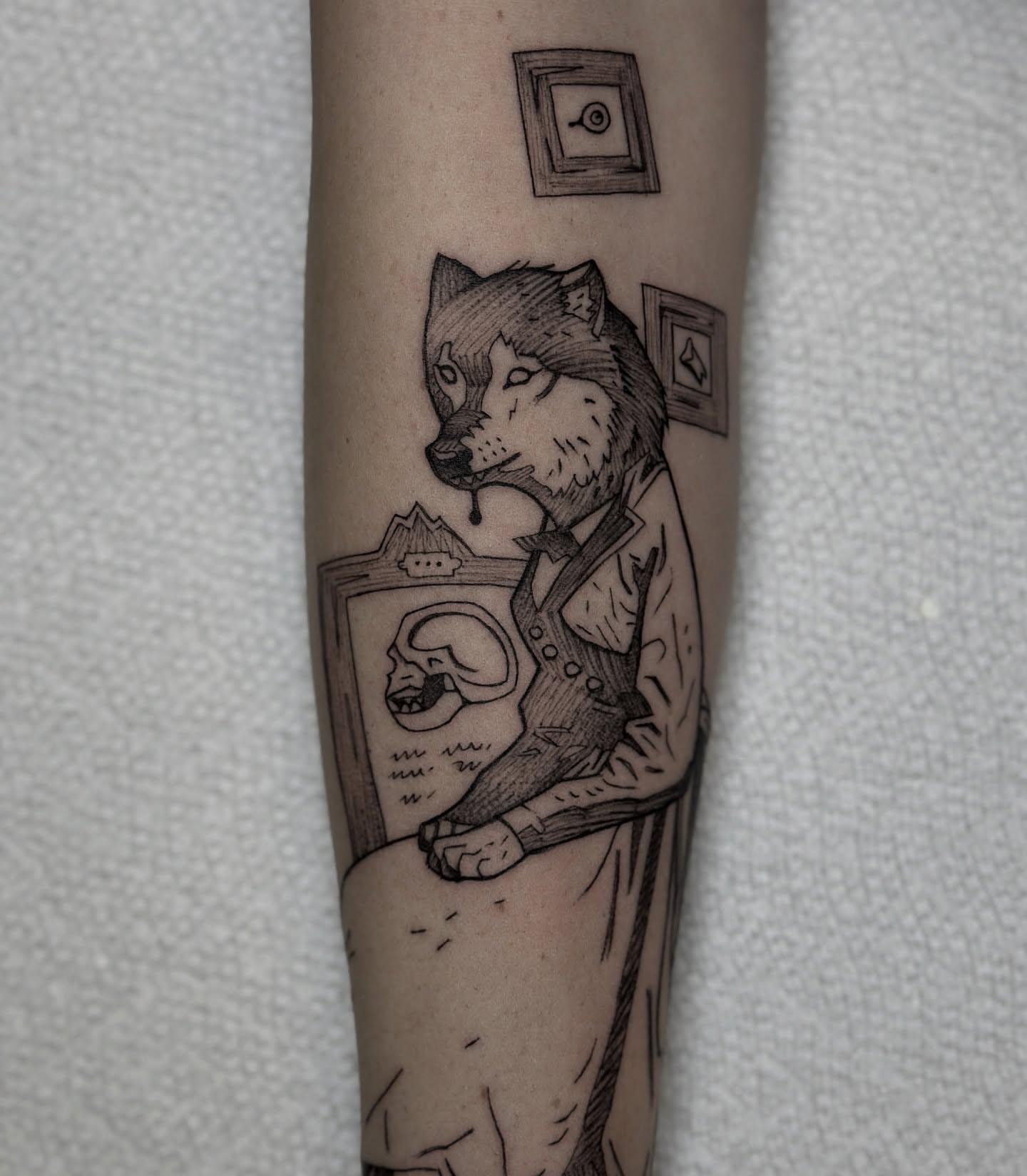 Wolf black and grey tattoo on the forearm by Robert McCollum