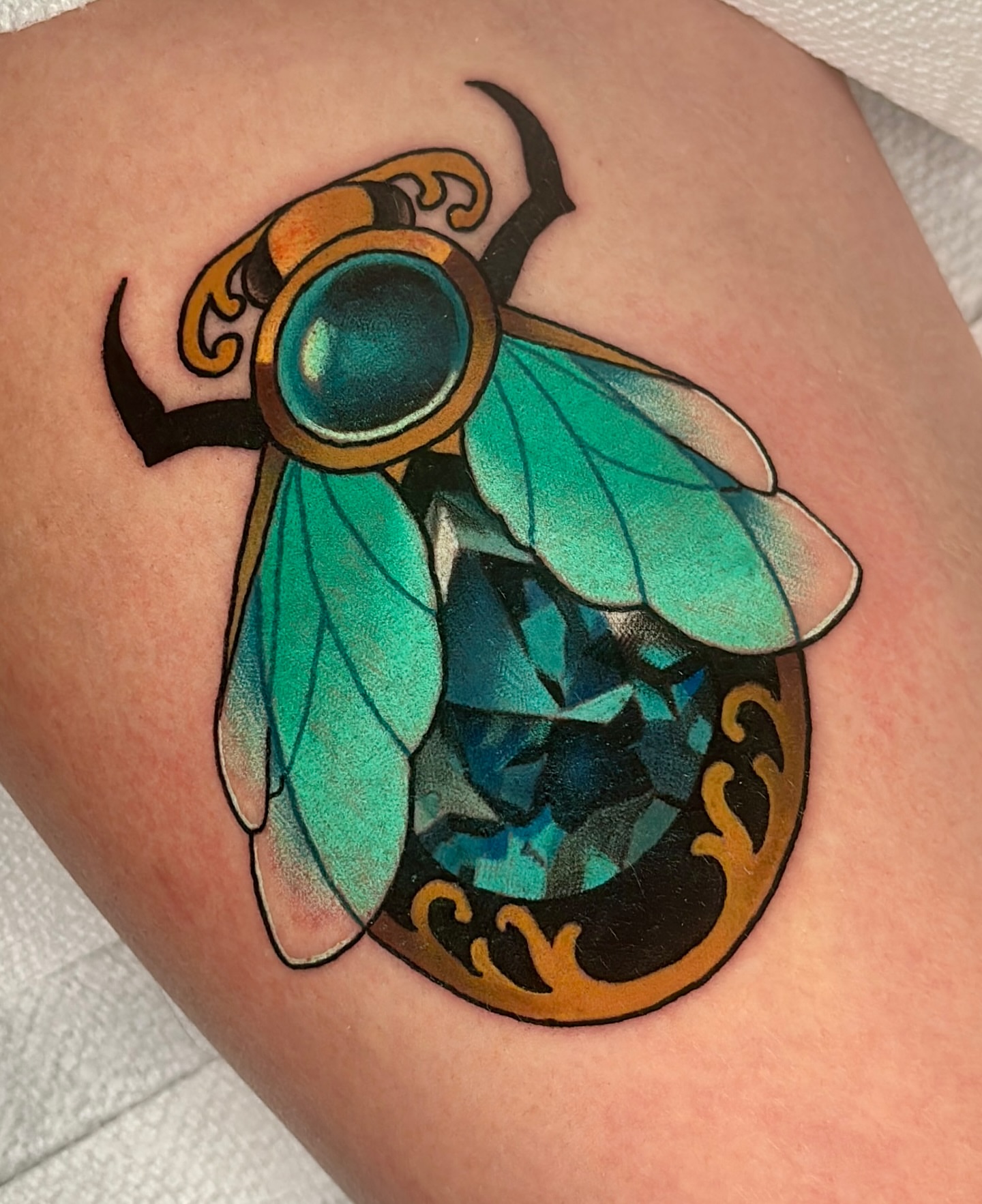 Insect geometric tattoo on the thigh by Latesha Burnley