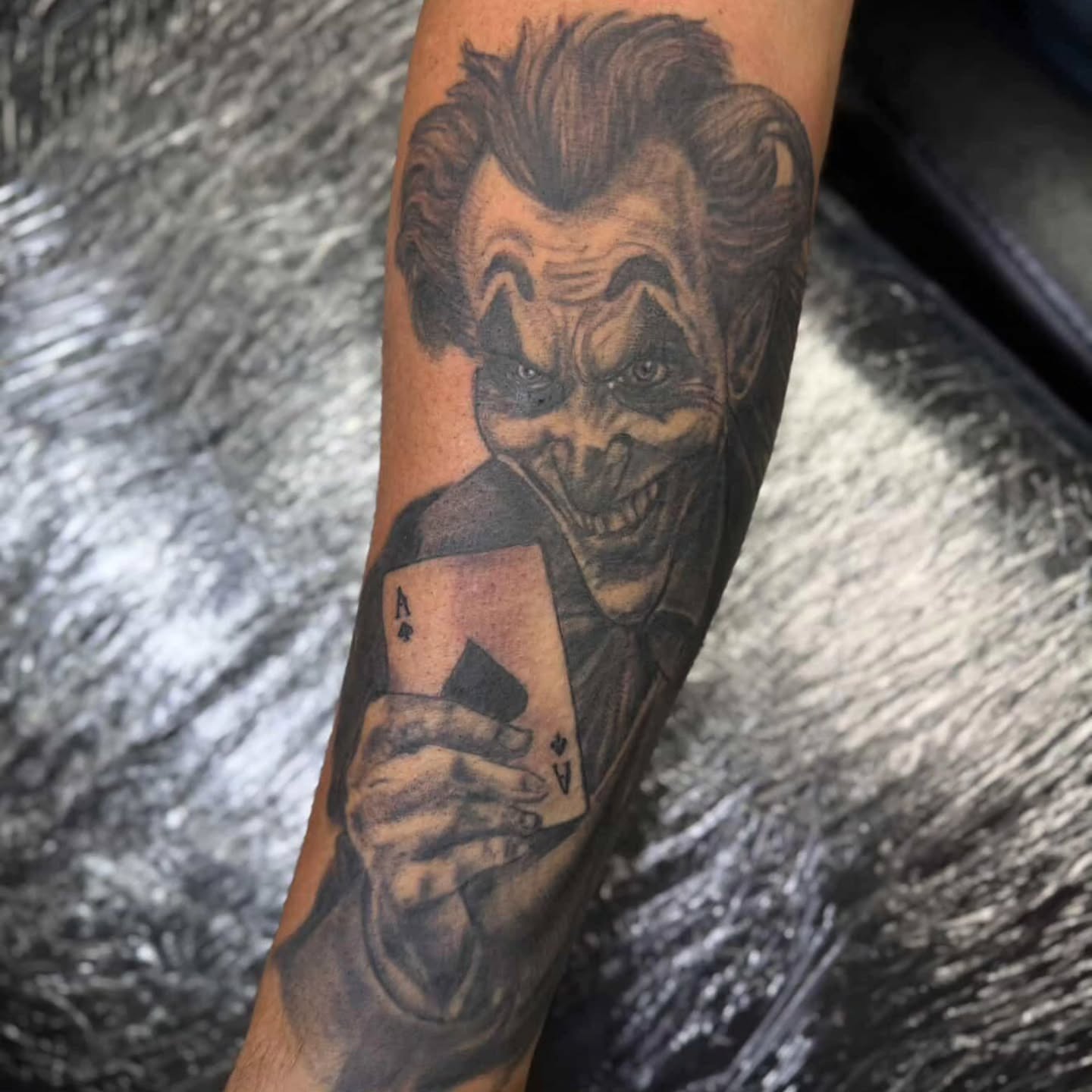 Joker realism tattoo on the forearm by Karen Cain