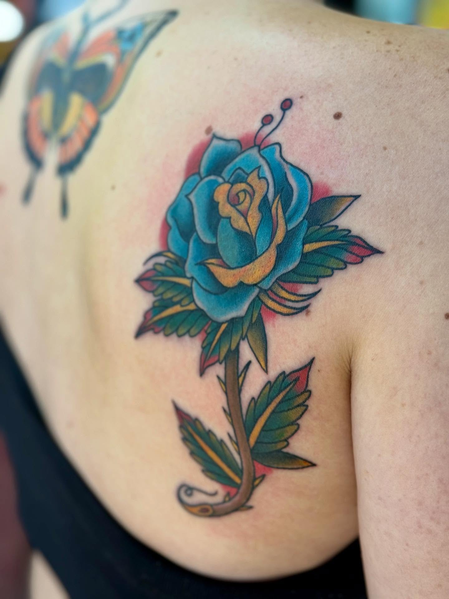 Blue rose American traditional tattoo on the shoulder by Sophie McTear
