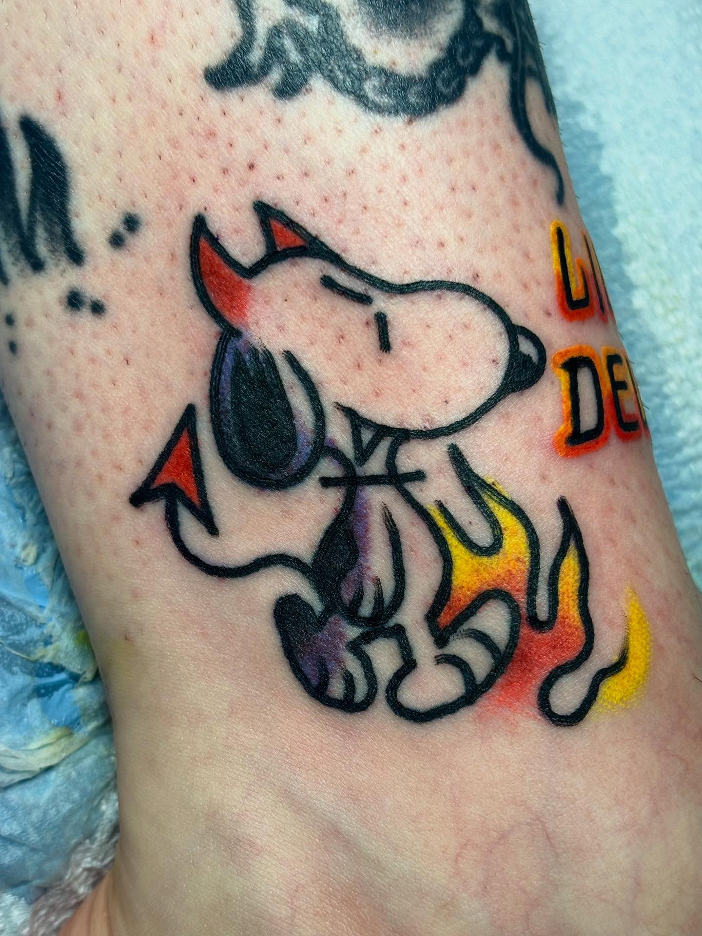 Snoopy new school tattoo on the forearm by Nick