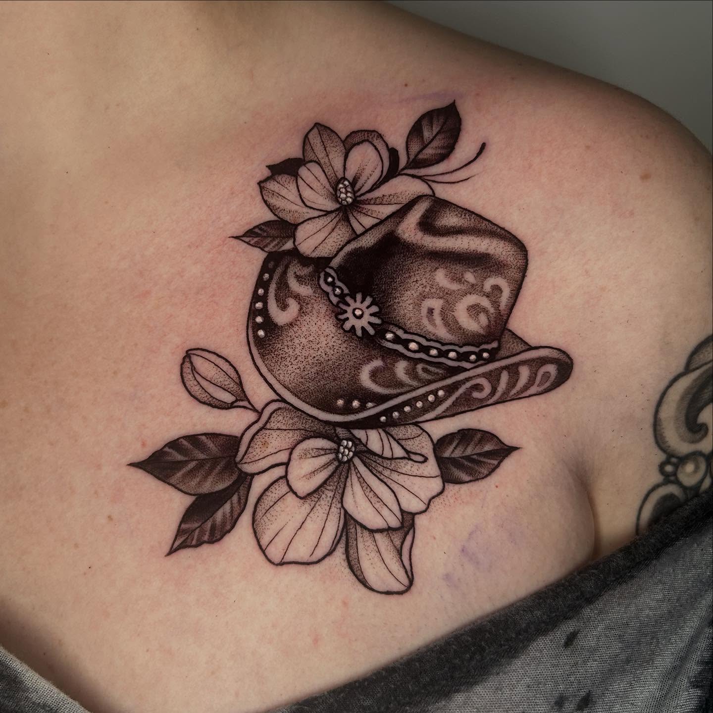 Cowboy hat and flowers dotwork tattoo on the shoulder by Whitney Harbin