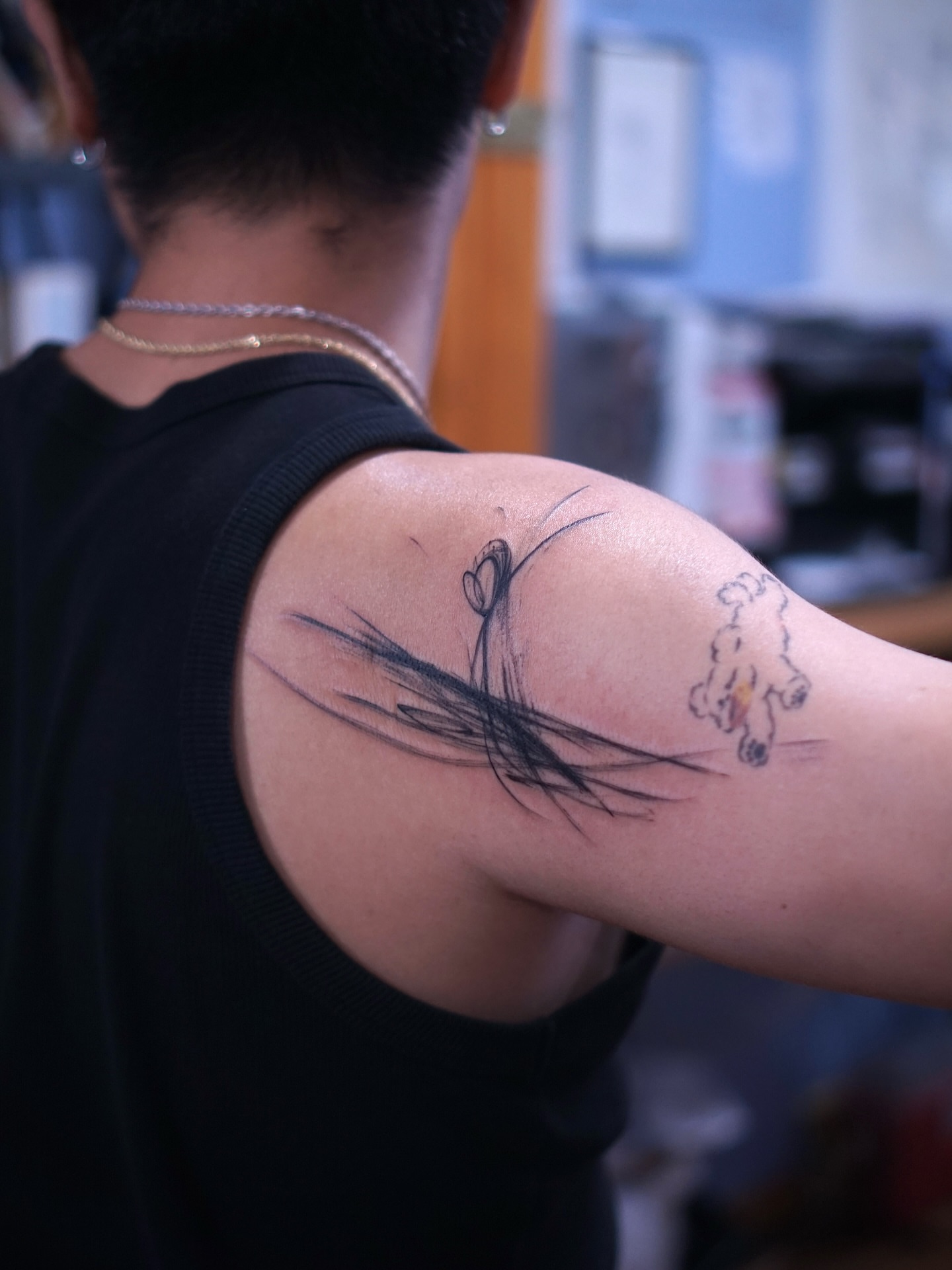 Dog and grass black and grey tattoo on the upper arm by Young one 영원